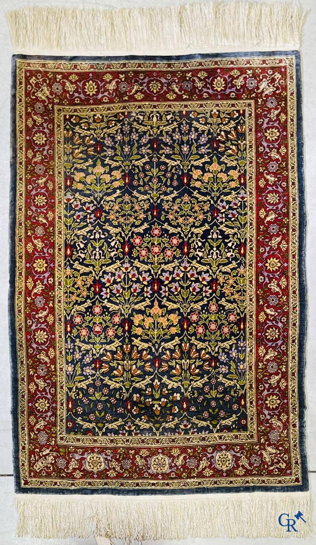 Oriental carpets, a finely hand-knotted silk carpet with floral decor.