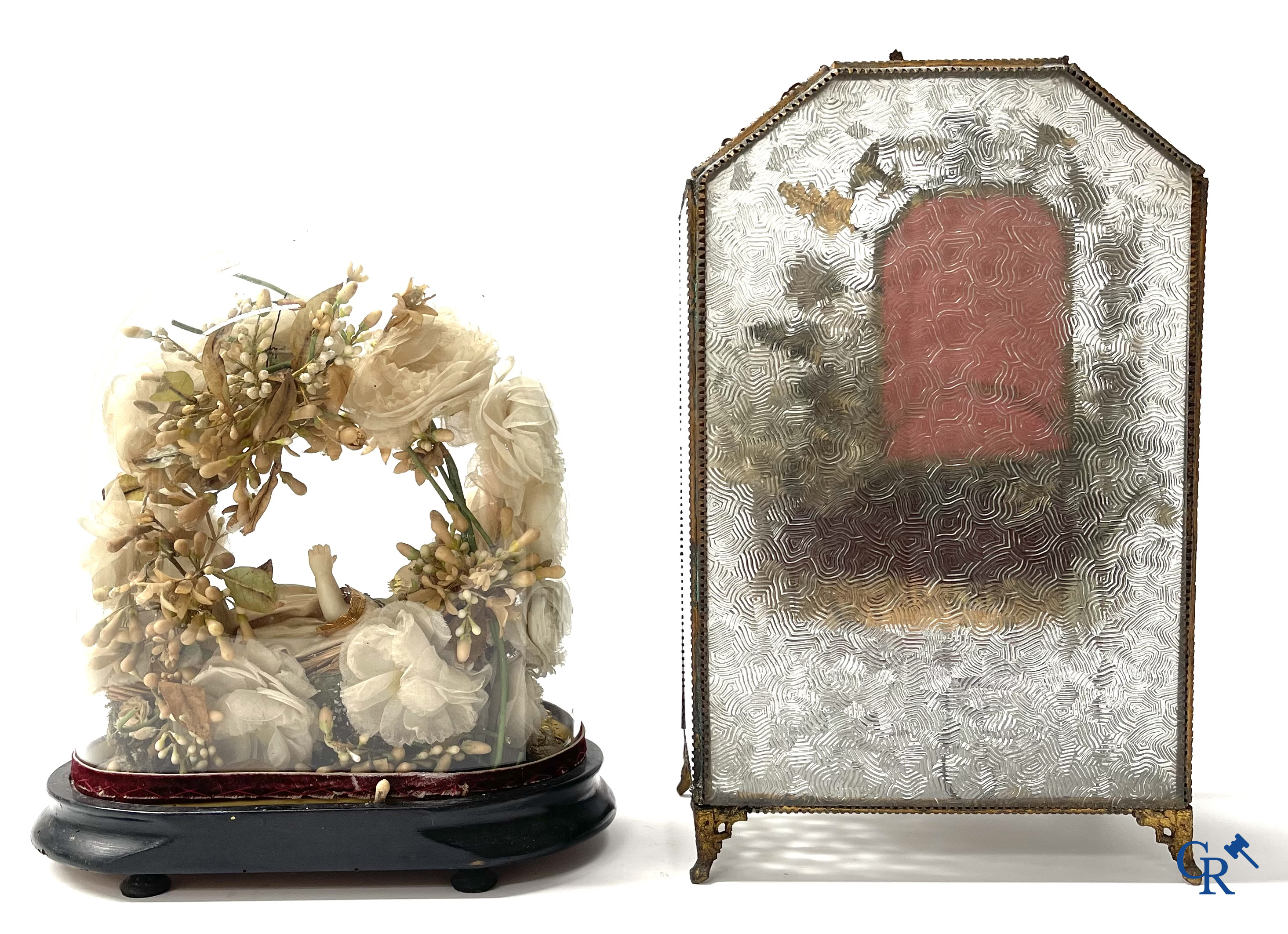 A globe in glass with a child in wax and a brass display case with bridal bouquet. Around 1900.