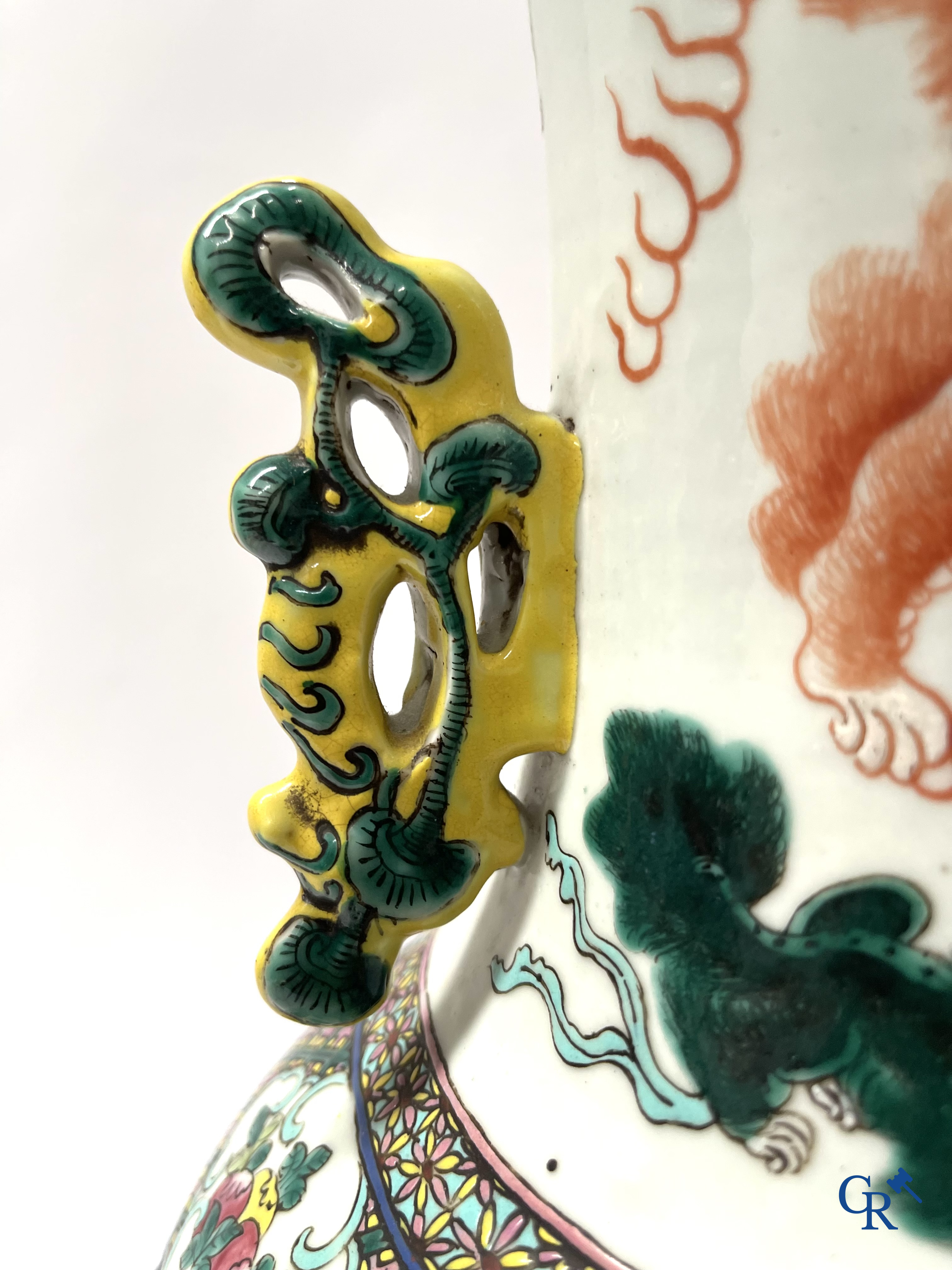 Asian Art, A pair of Chinese famille rose vases with peacocks and Fo dogs. 19th century.