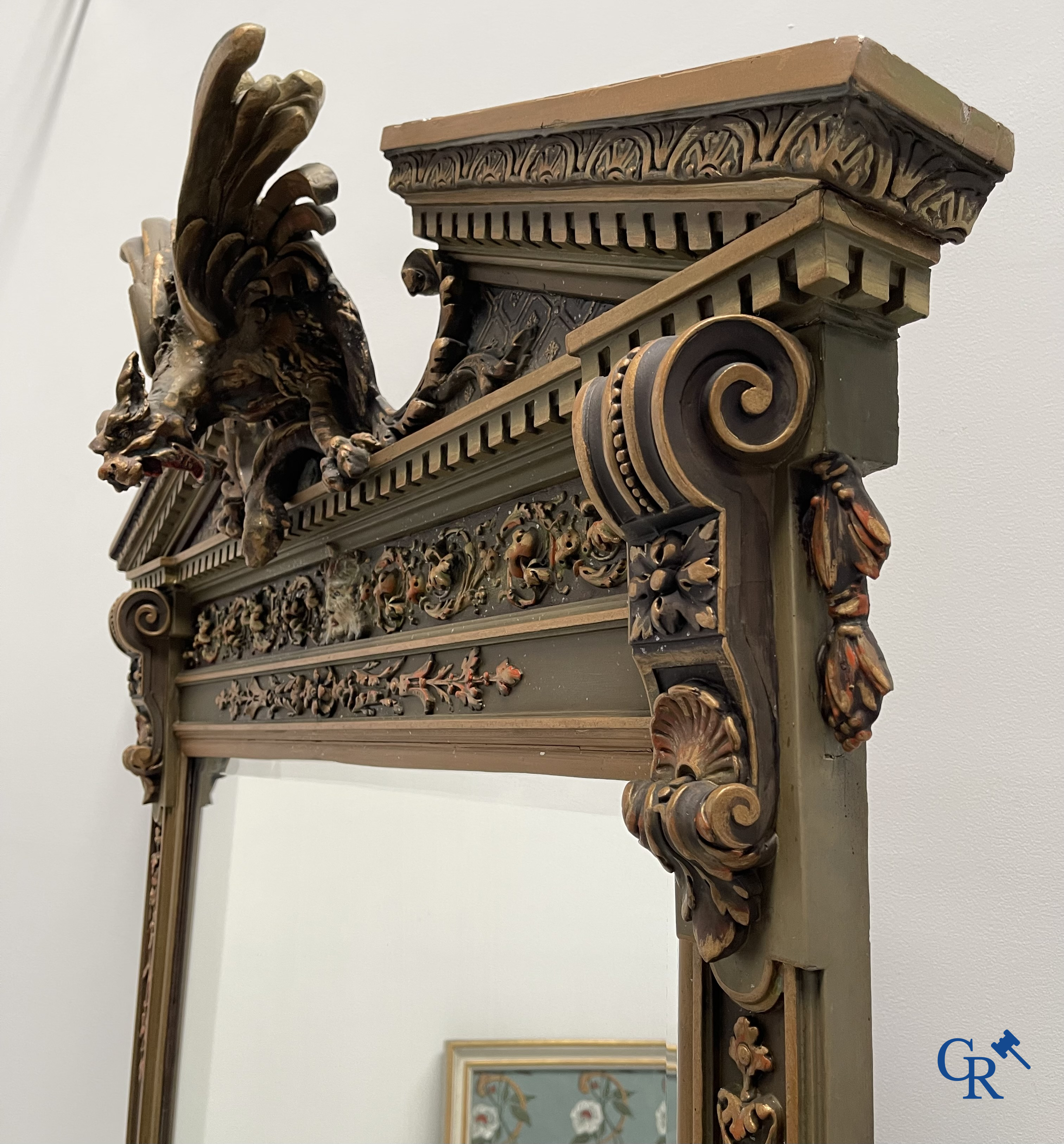 A large patinated fireplace mirror with a dragon. Around 1900.