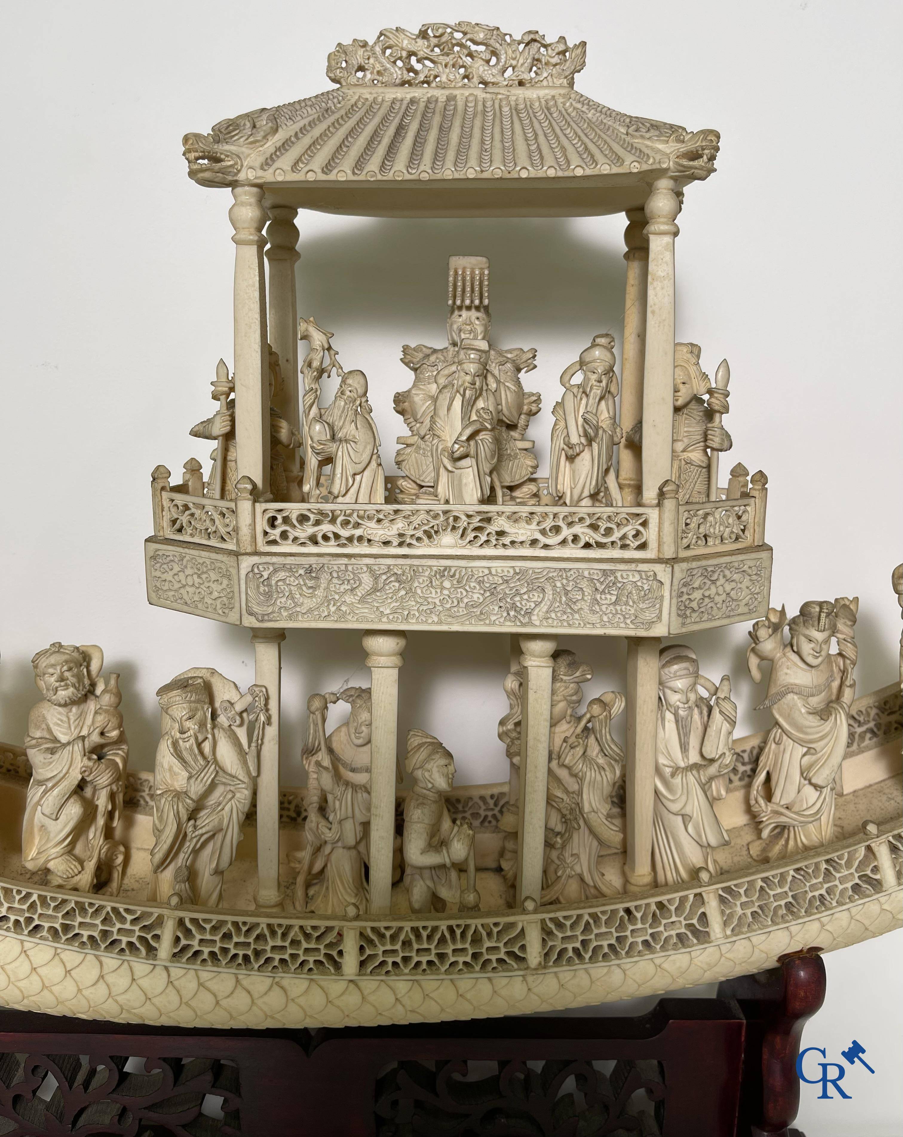 Asian Art: A large Chinese ivory dragon boat on a wooden pedestal. 19th century.