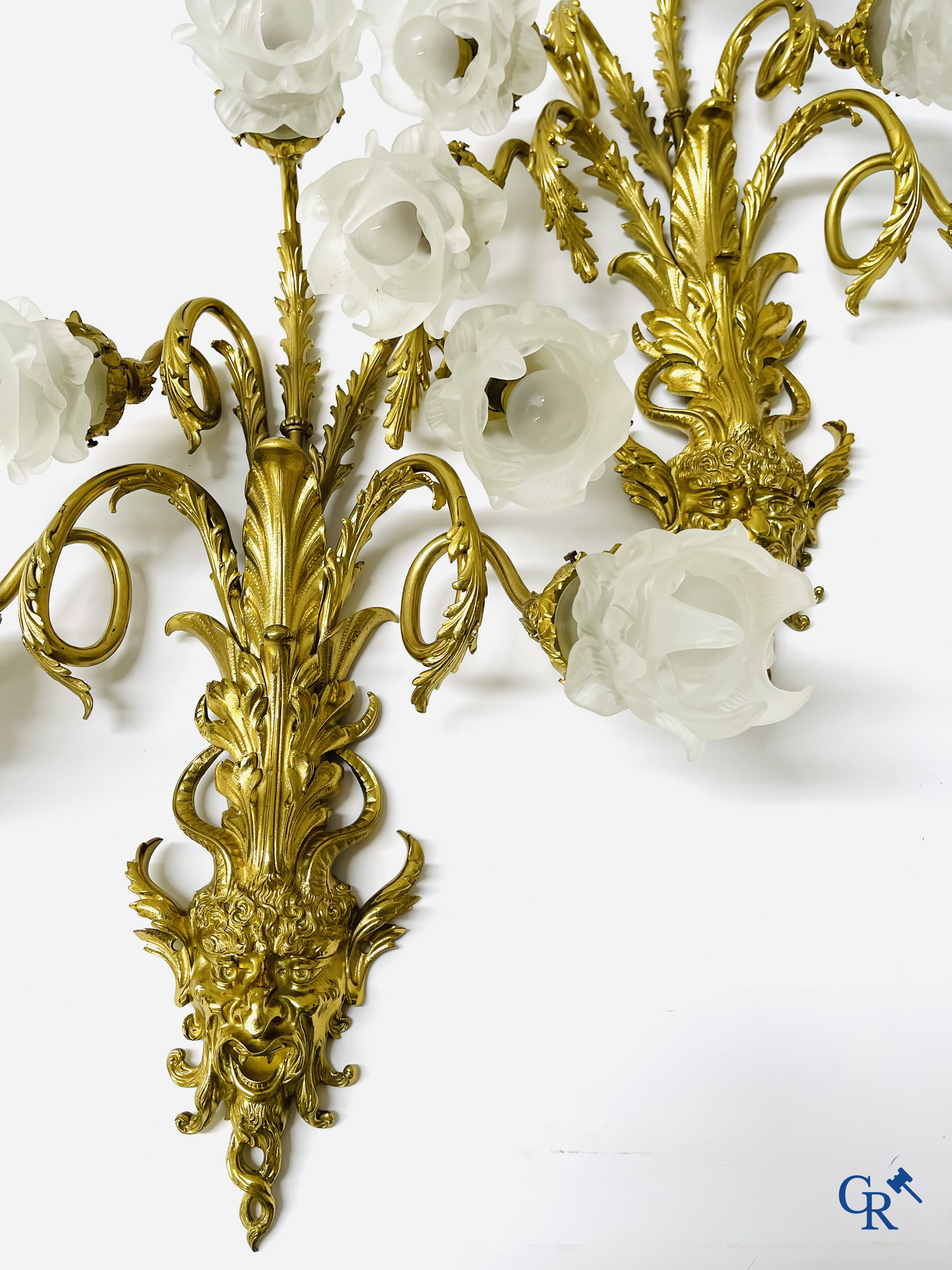 A pair of imposing bronze wall lights with 5 light points each and sater heads. Napoleon III style.