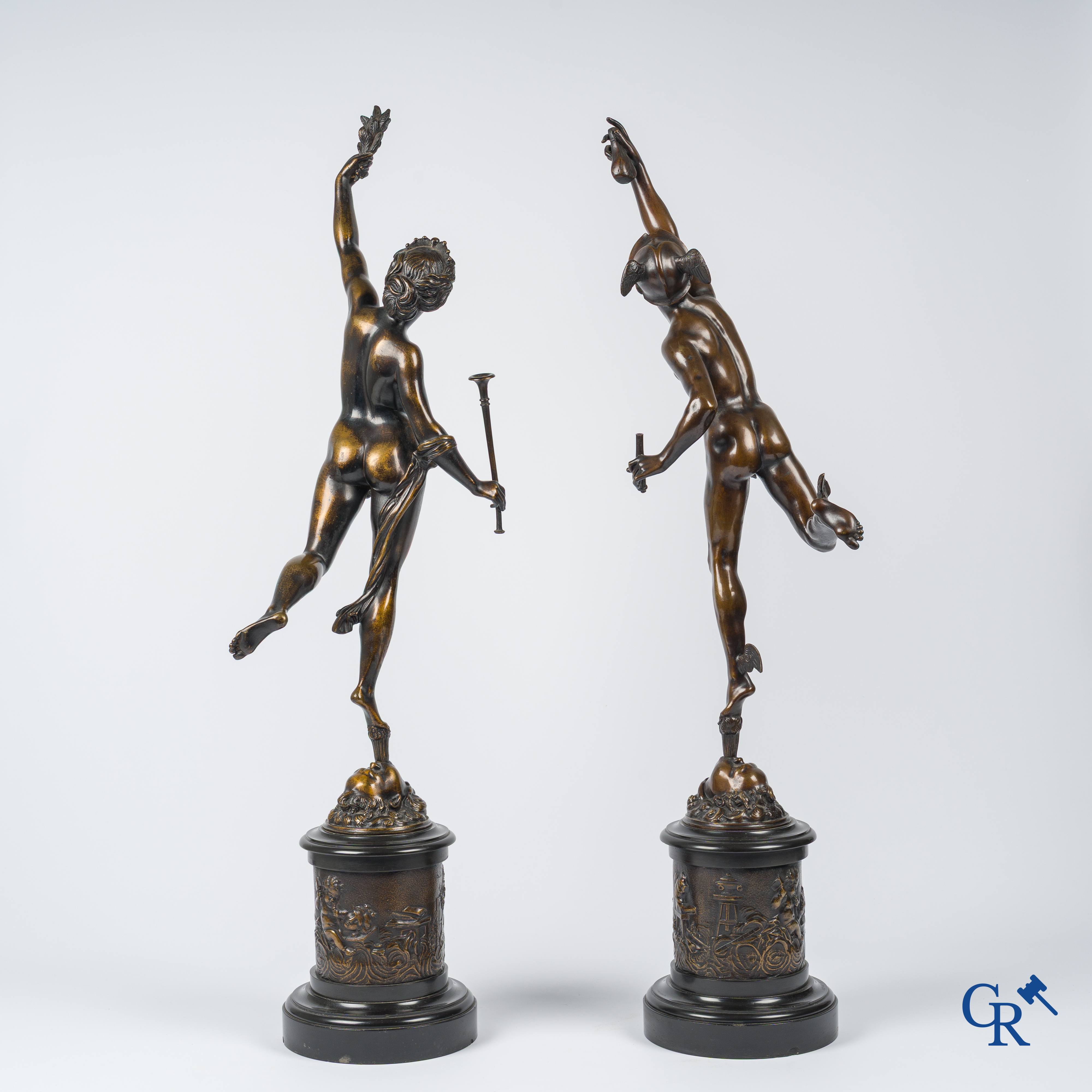 A pair of imposing bronze statues in the antique style after a model by Jean De Bologne.