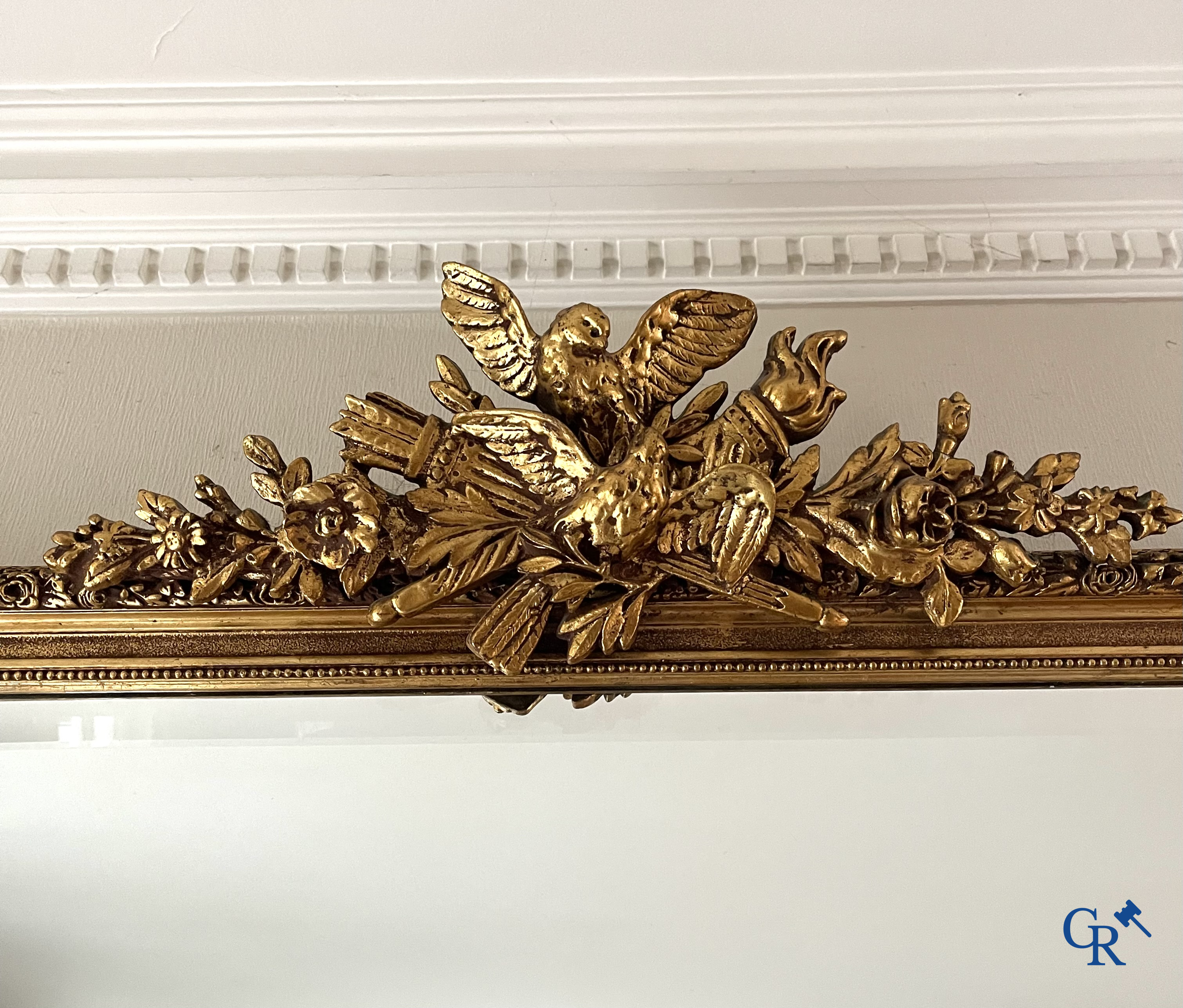 A large gilded fireplace mirror in LXVI style. Circa 1920.