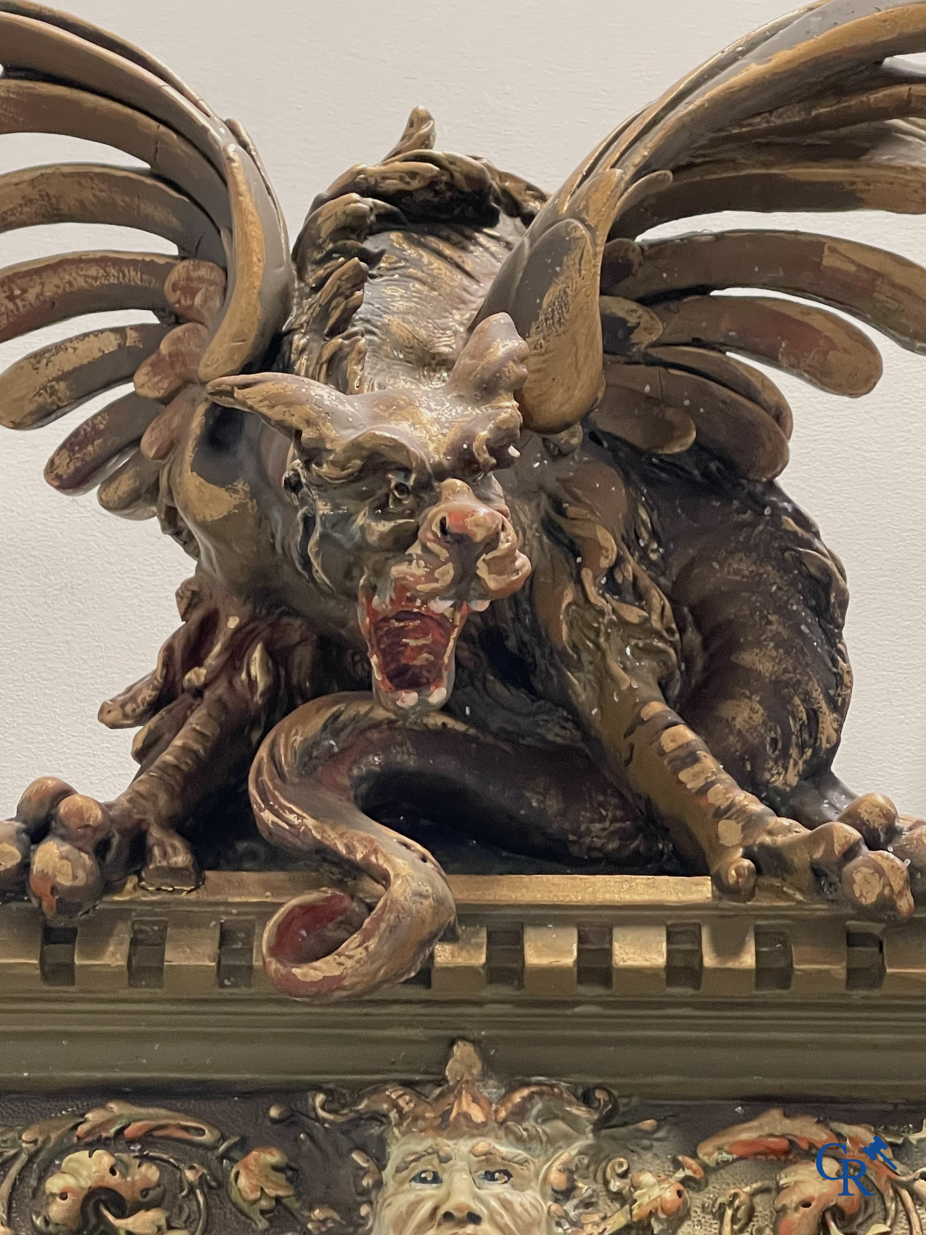 A large patinated fireplace mirror with a dragon. Around 1900.