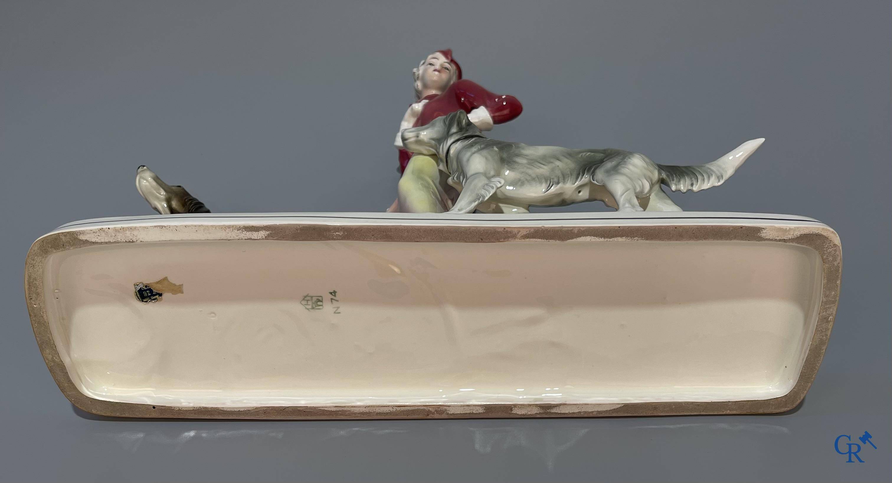 European porcelain, Katzhutte Hertwig, an Art Deco statue of a lady with dogs. Marked and numbered 74.
