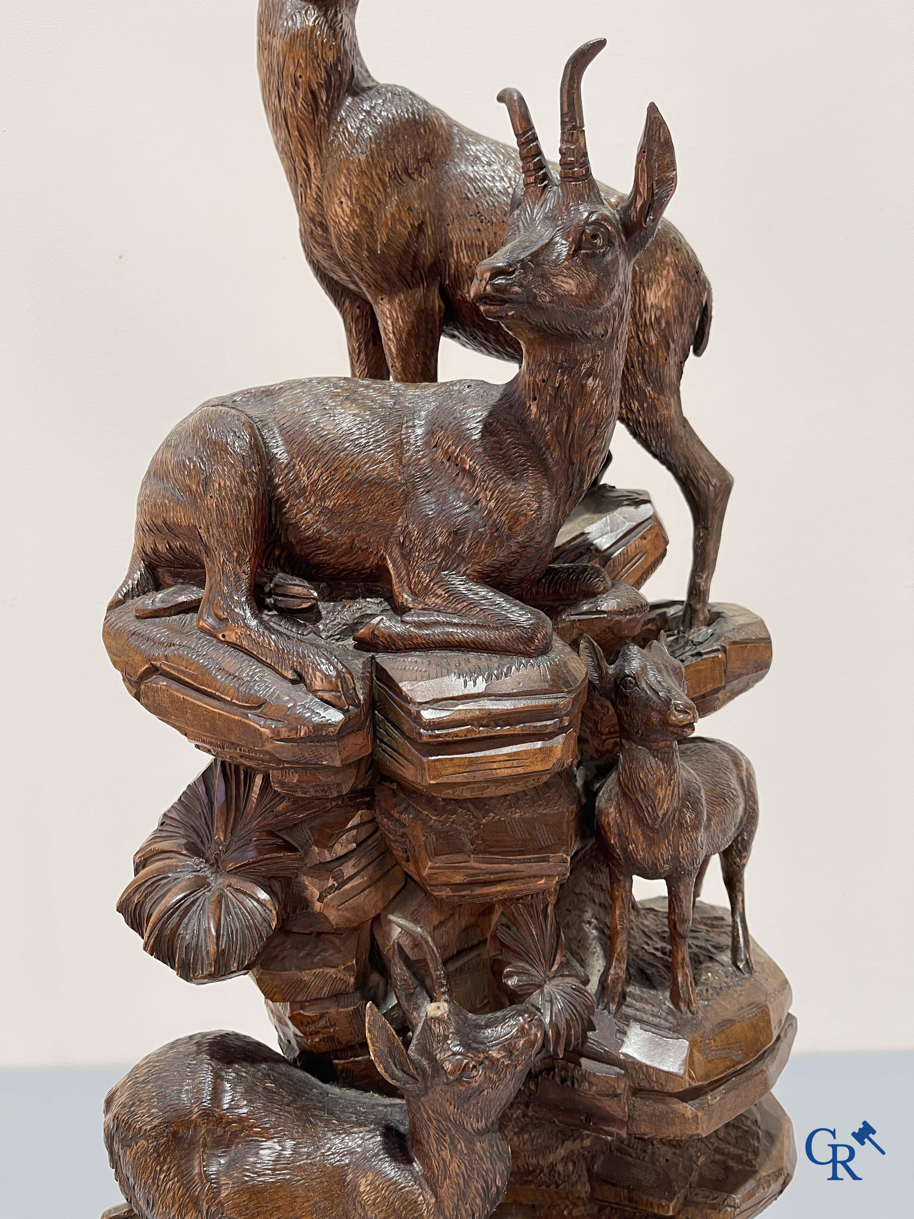 Imposing wood sculpture with chamois on a rocky mountain landscape in so-called "black forest". German work, late 19th century.