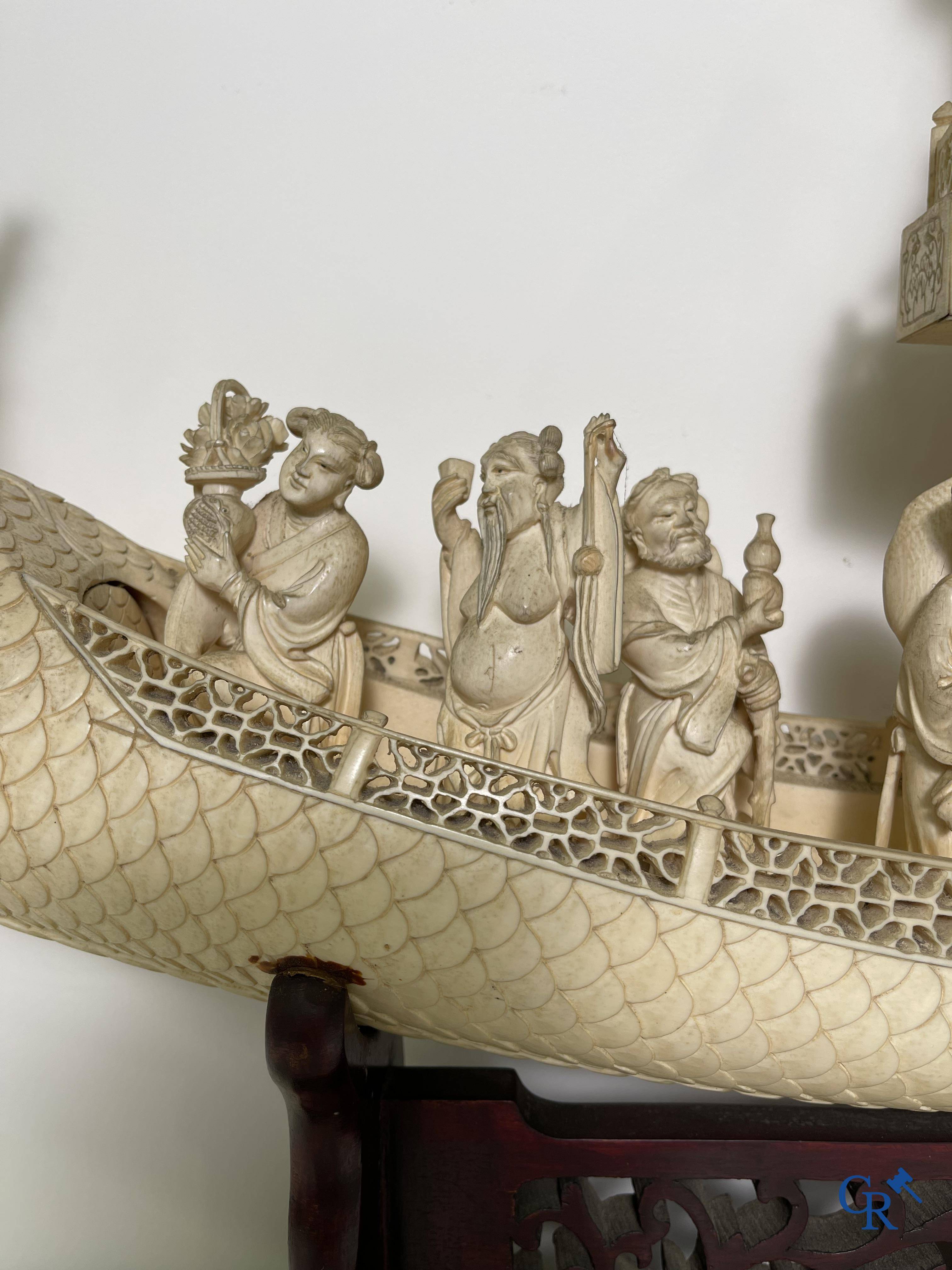 Asian Art: A large Chinese ivory dragon boat on a wooden pedestal. 19th century.