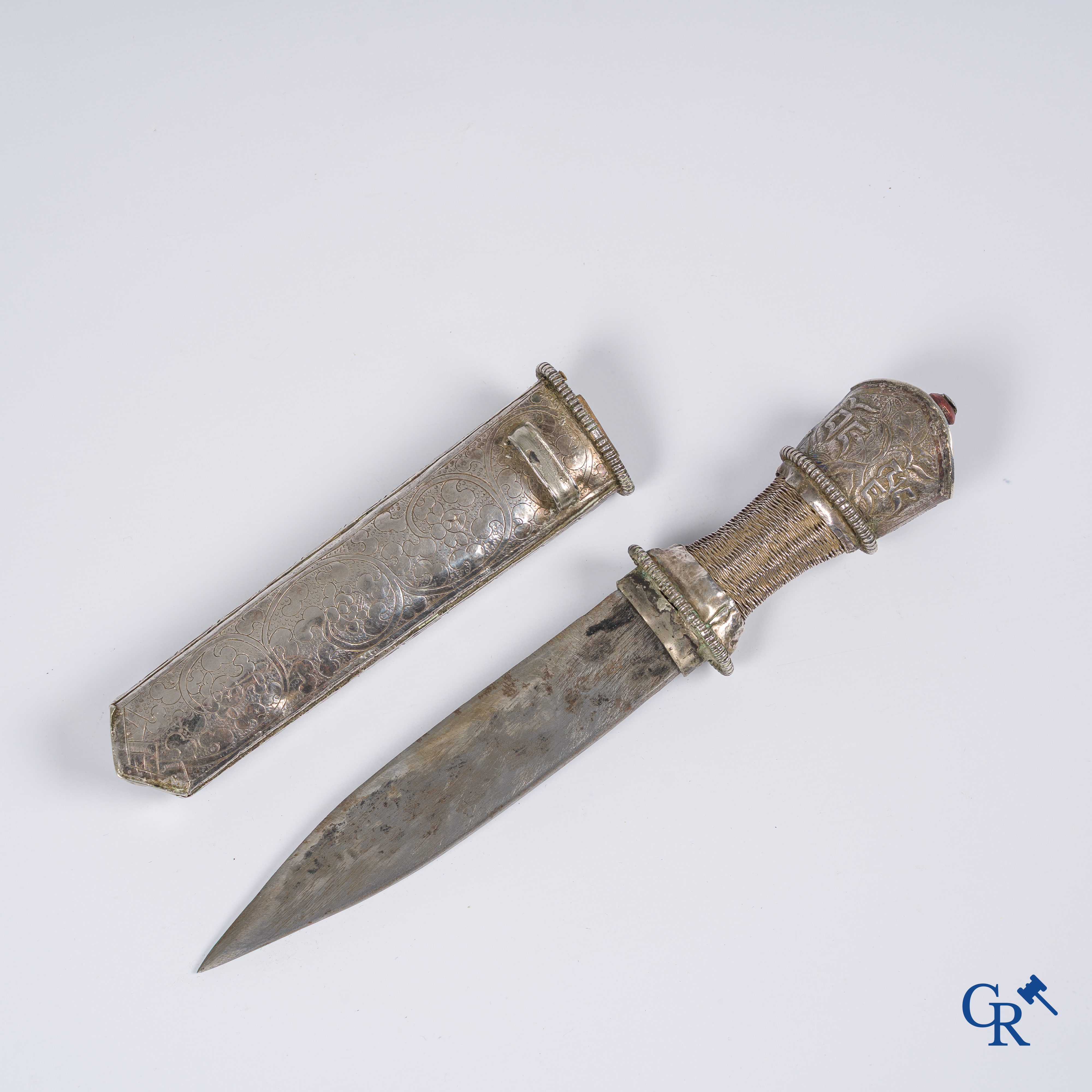 Asian Art, a richly carved silver Tibetan dagger with dragon motif. 19th century.