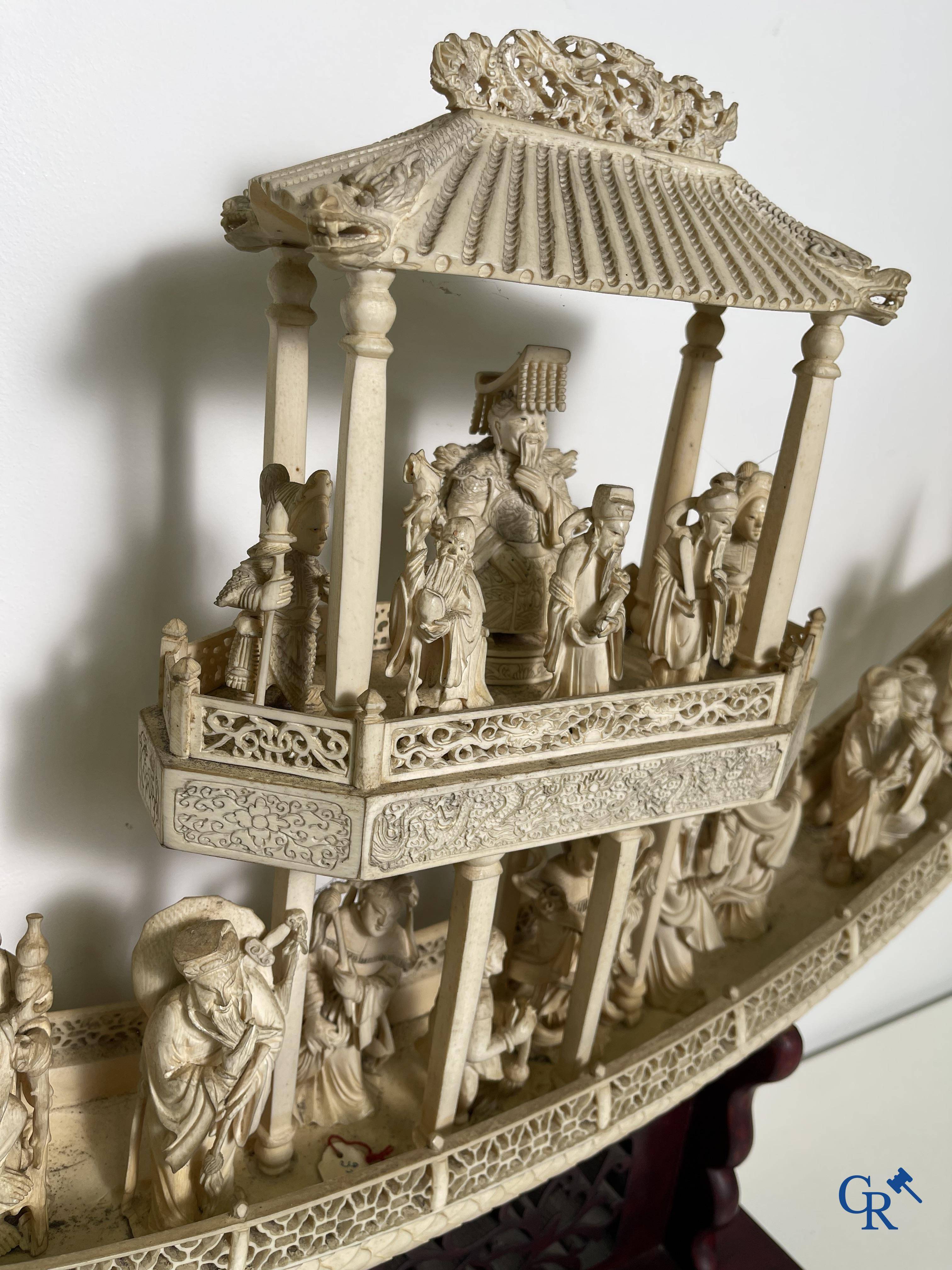 Asian Art: A large Chinese ivory dragon boat on a wooden pedestal. 19th century.