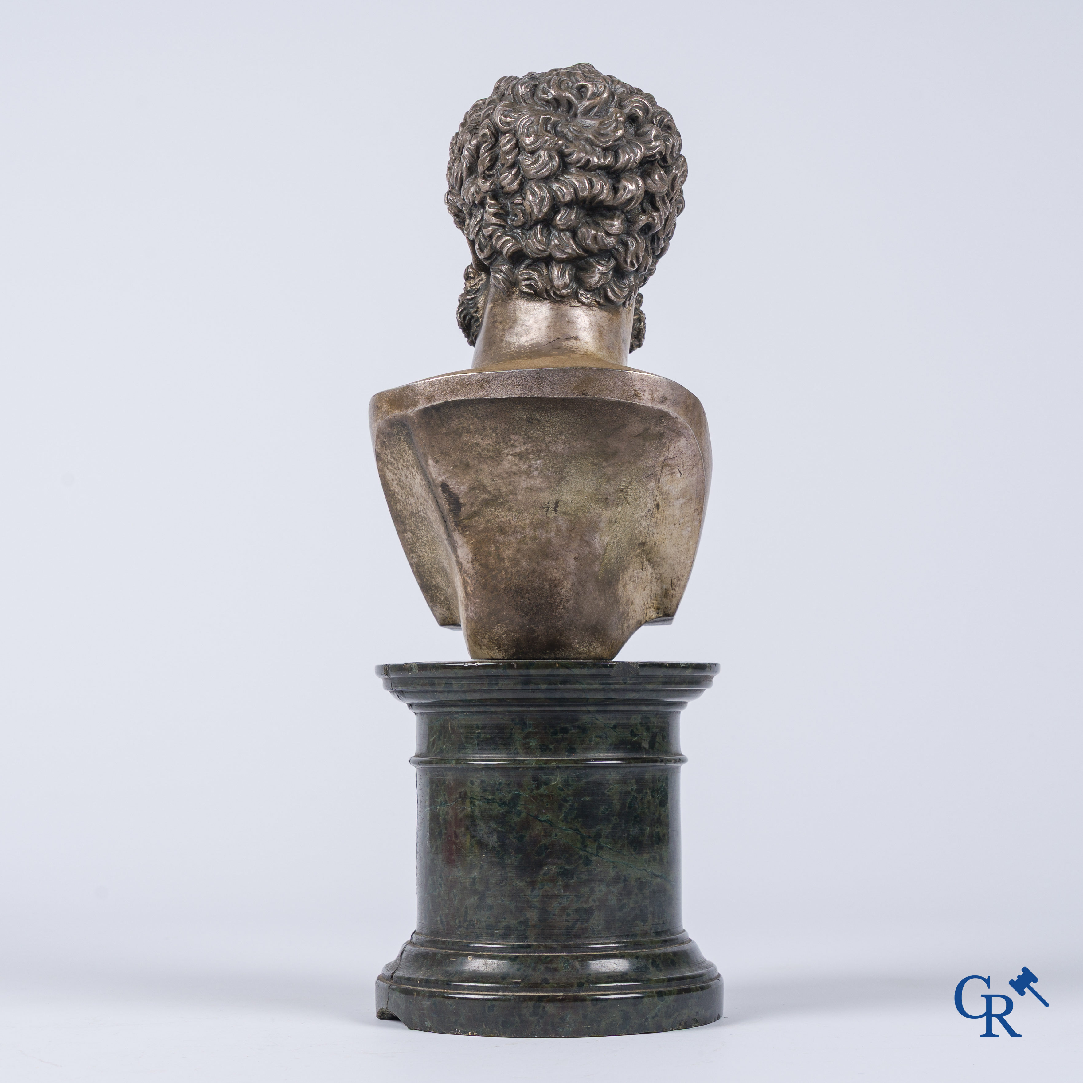A silvered bronze bust of Lucius Verus on a dark green serpentine pedestal. 19th century.