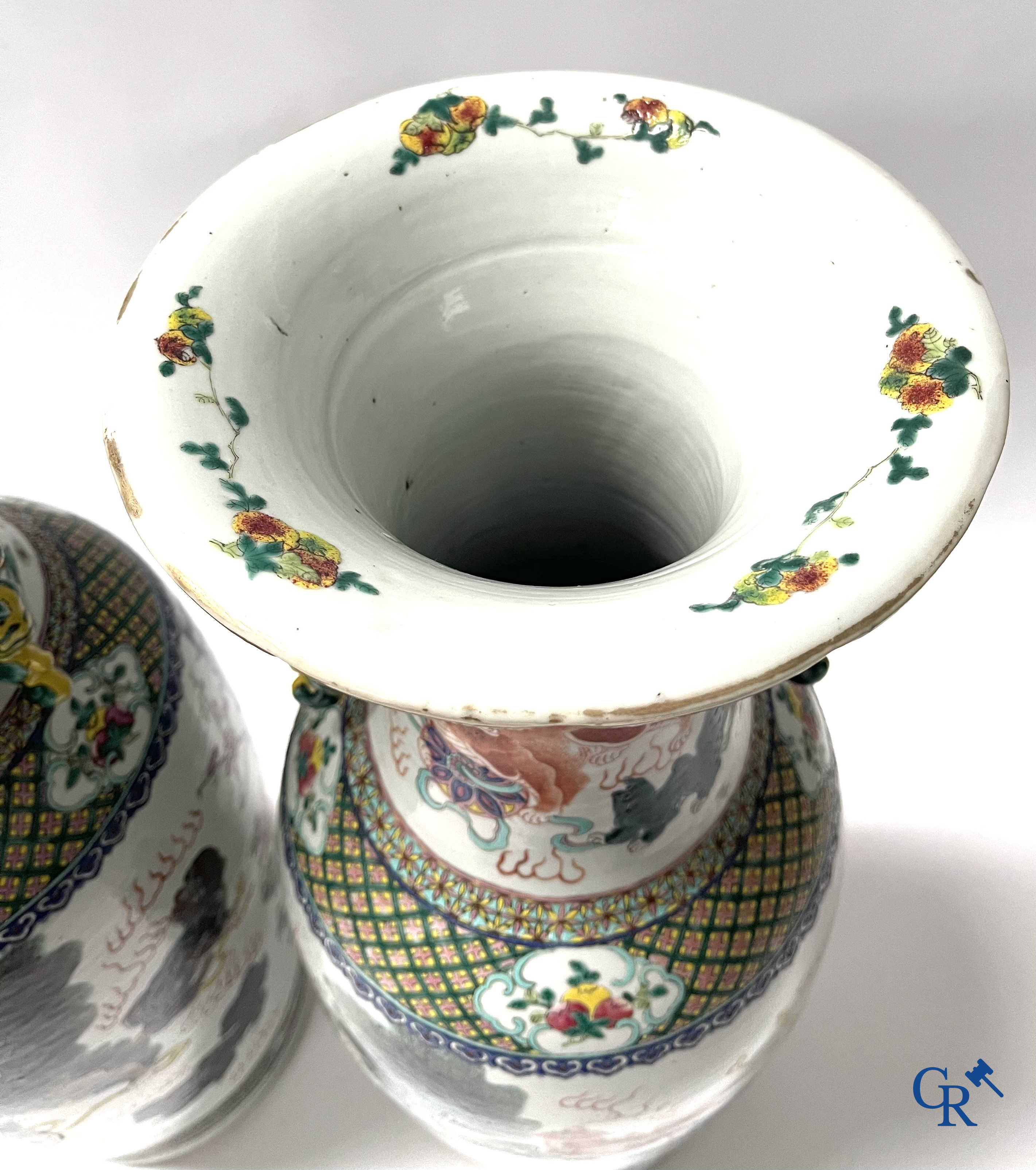 Asian Art, A pair of Chinese famille rose vases with peacocks and Fo dogs. 19th century.