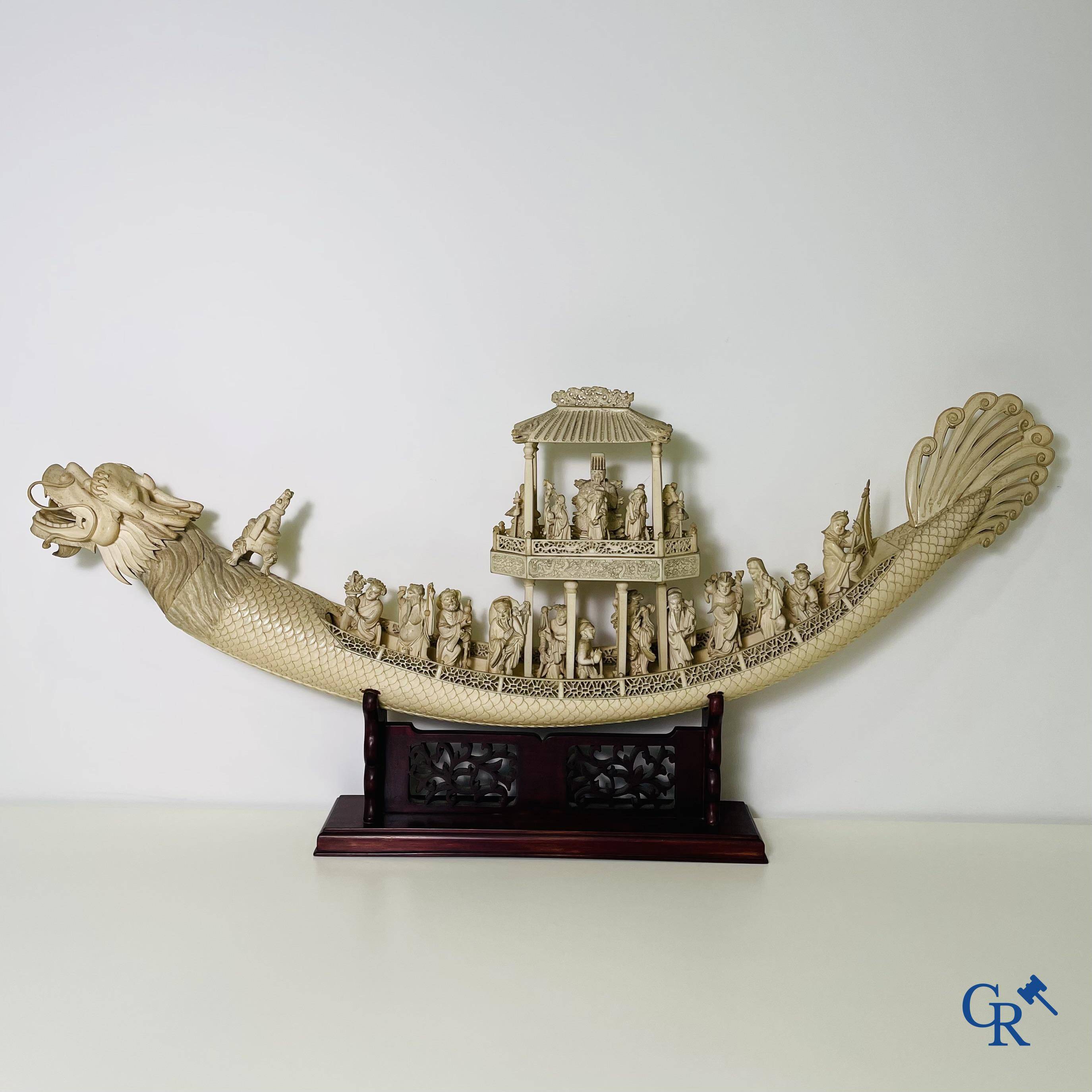 Asian Art: A large Chinese ivory dragon boat on a wooden pedestal. 19th century.