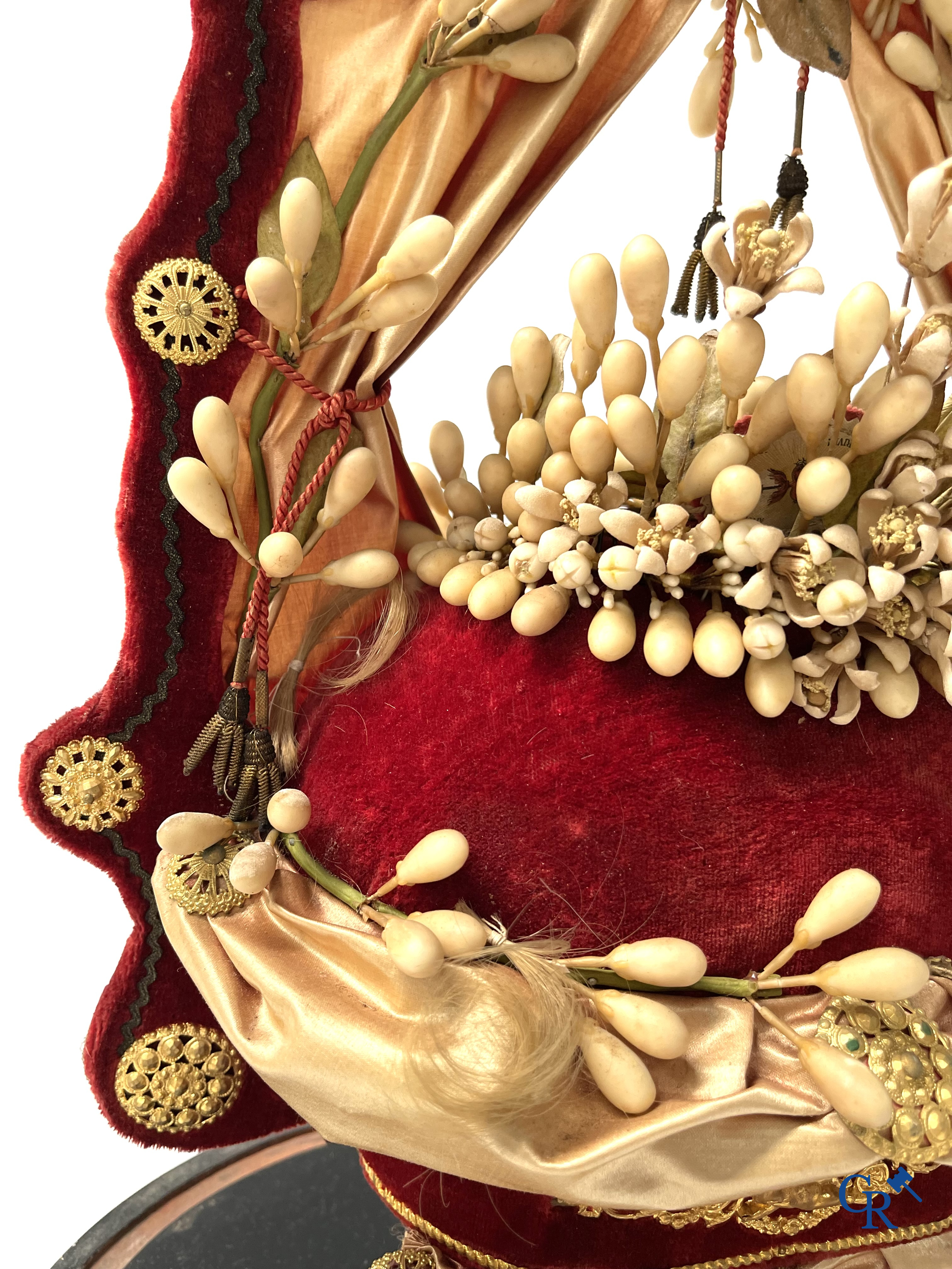 2 glass domes with a bridal bouquet on a base decorated with ornaments in gilded brass. circa 1900.