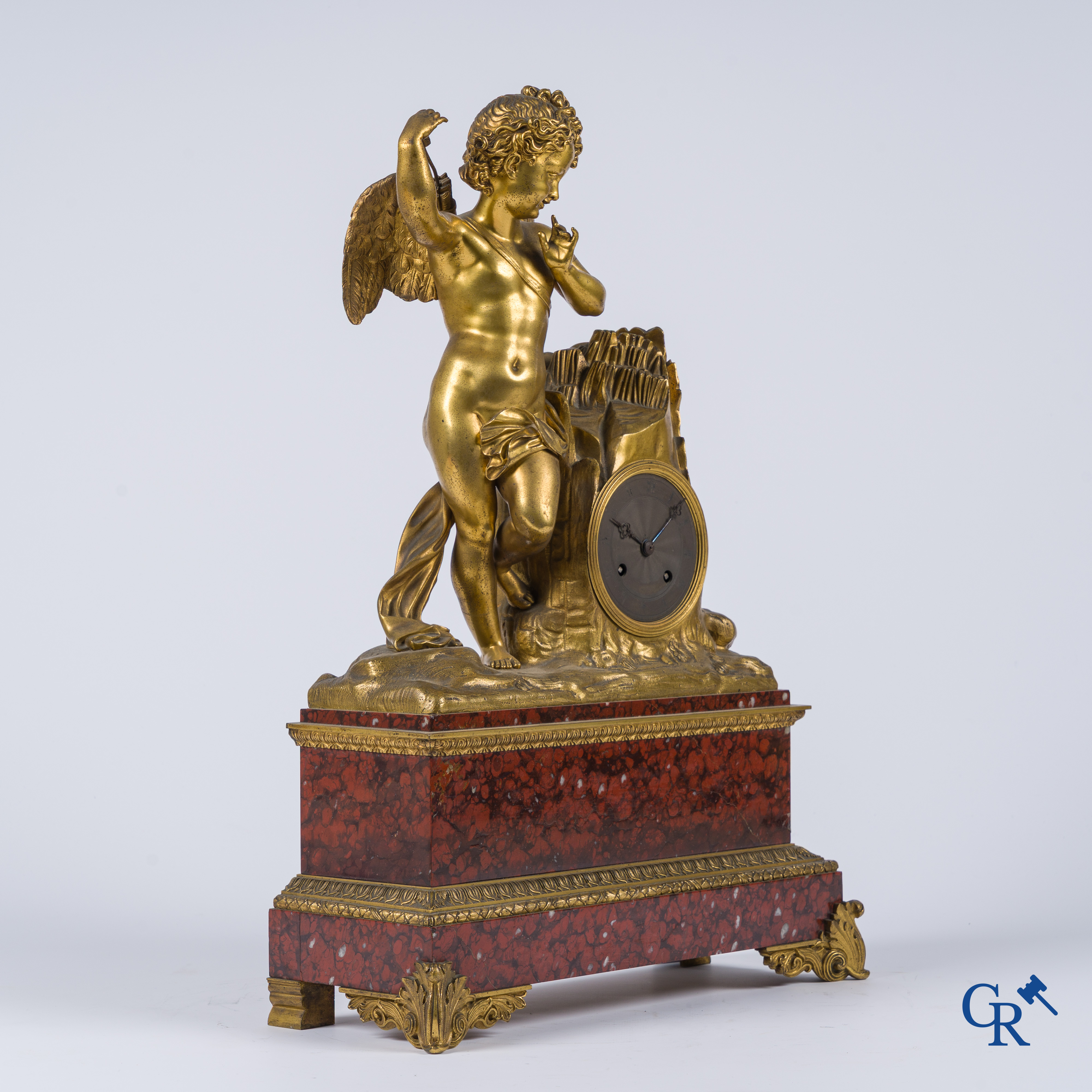 Charles X, a pendulum with finely chiseled cupid in gilded bronze. Red veined marble pedestal, circa 1840.