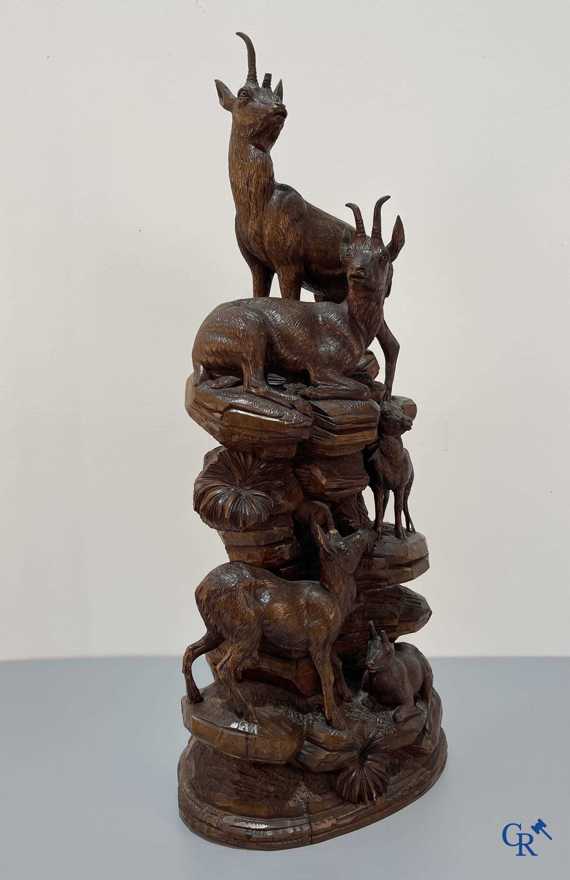 Imposing wood sculpture with chamois on a rocky mountain landscape in so-called "black forest". German work, late 19th century.