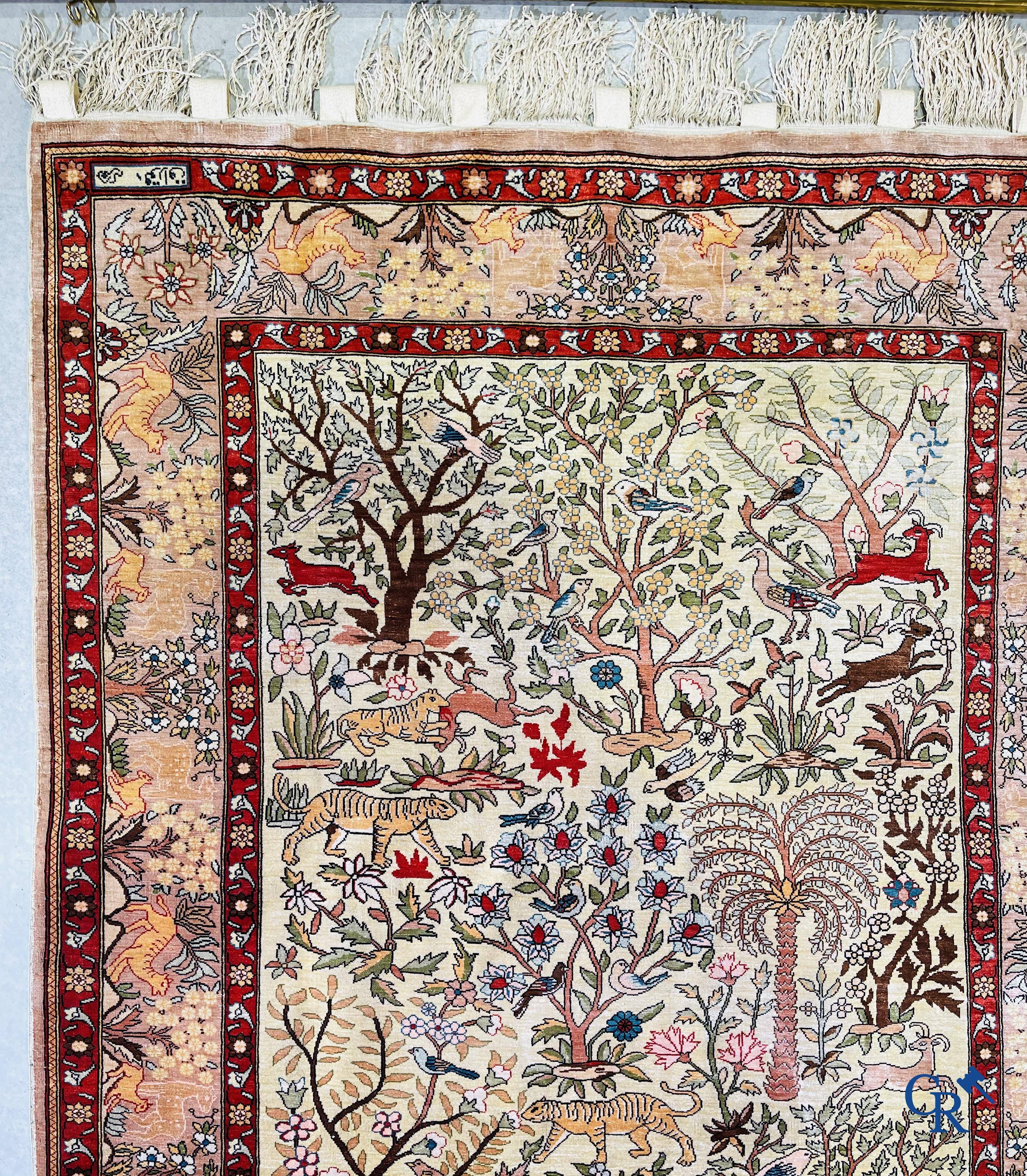 Oriental rugs, a fine hand-knotted silk tapestry with animals in a forest. Signed.