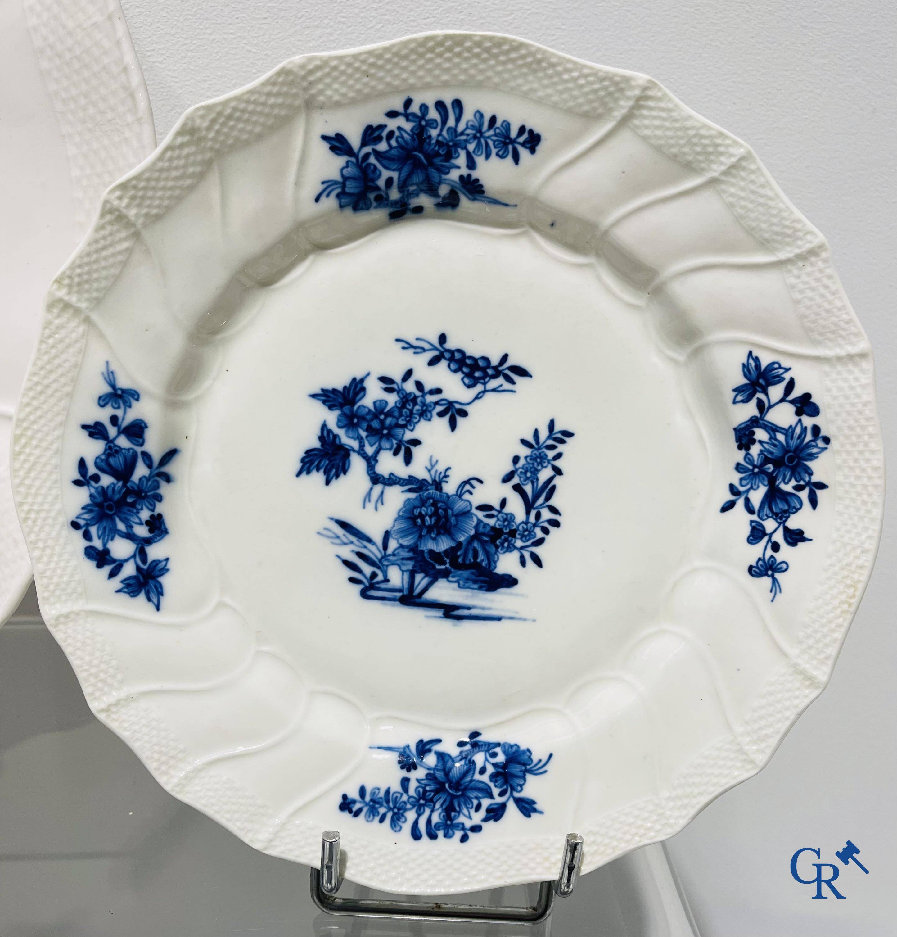 European porcelain, Tournai. 13 plates with blue decor and a large monochrome dish. 18th century.