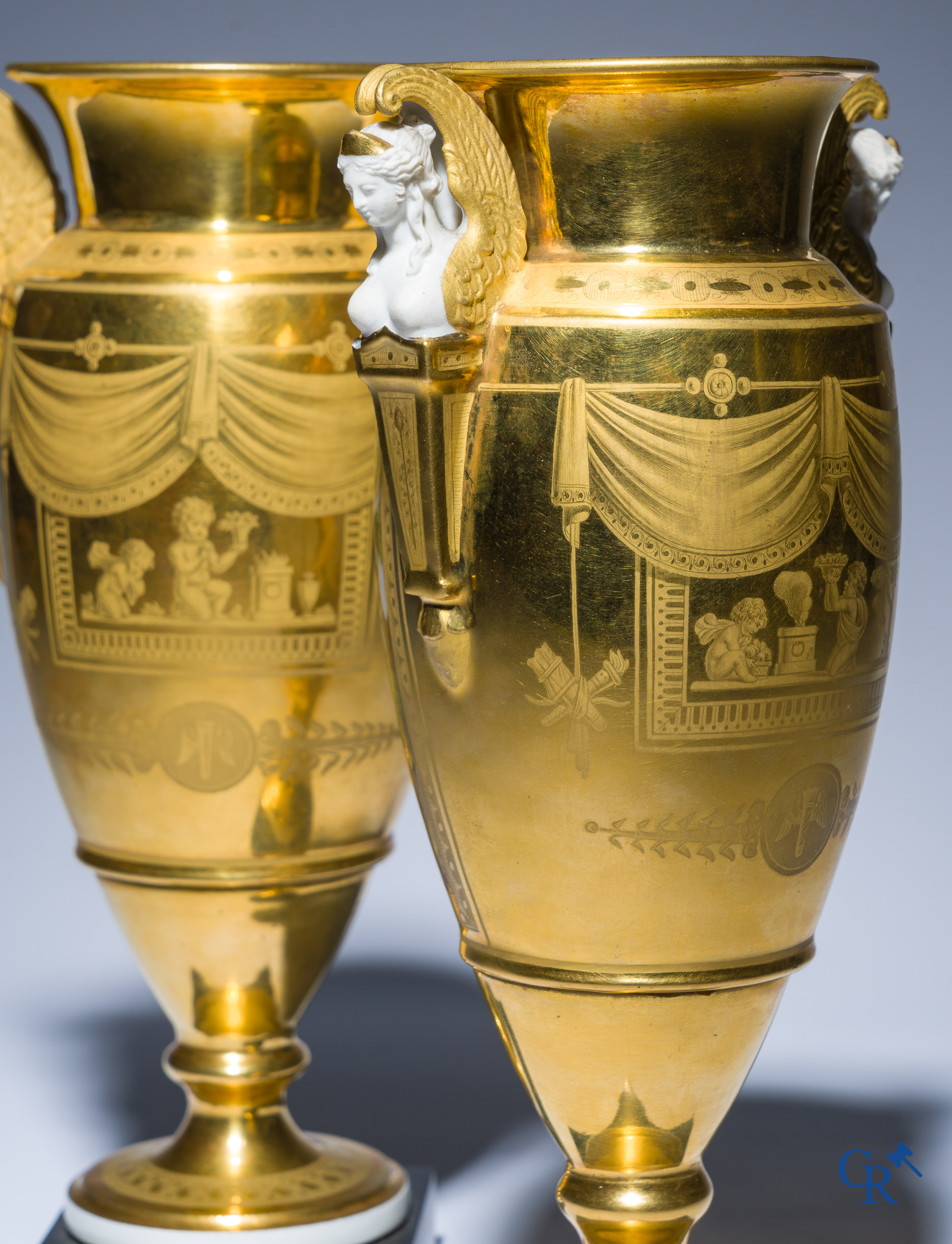 Empire, a pair of finely gilded and decorated vases in porcelain and biscuit on a marble pedestal, Circa 1810.