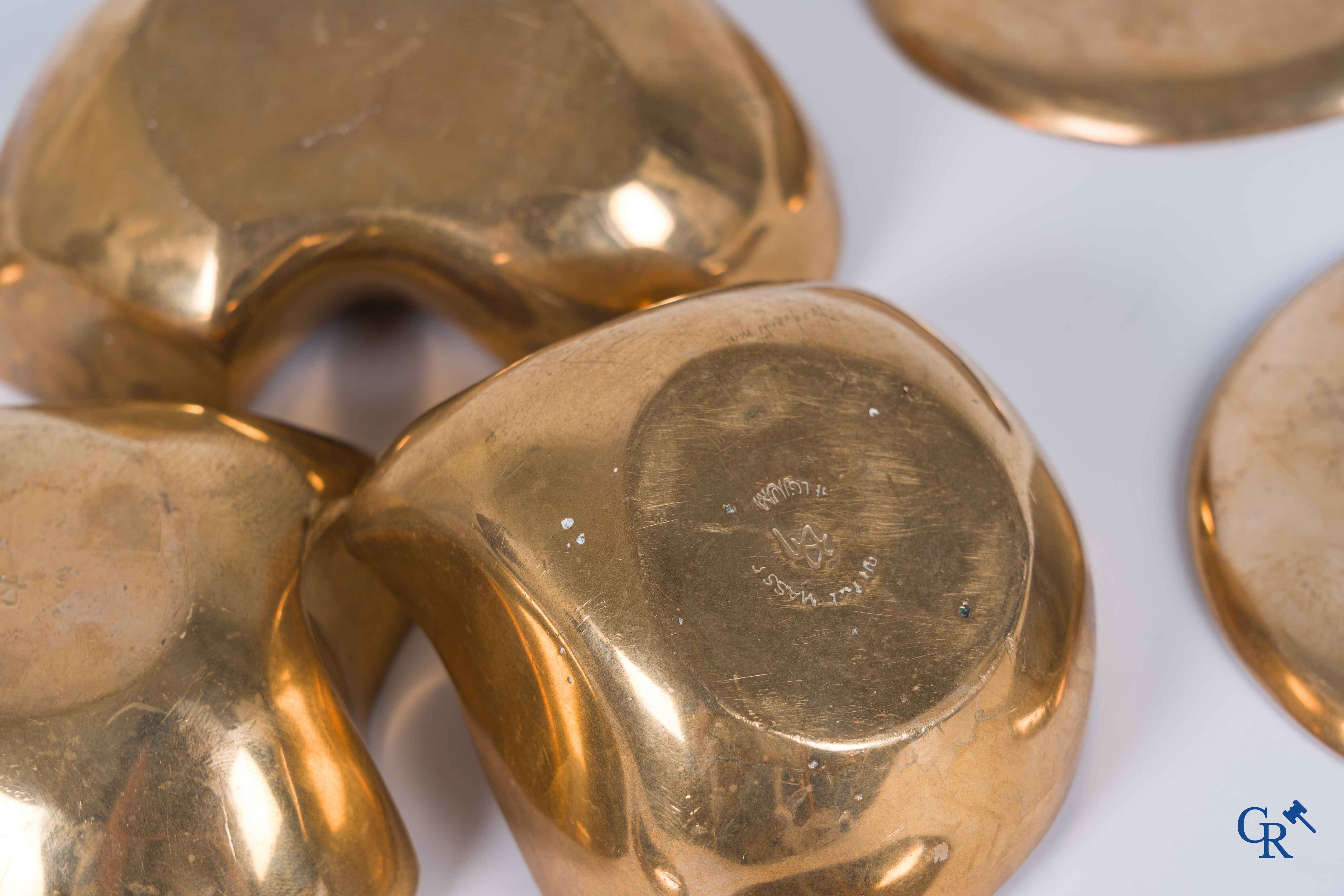 Margrit Van Nuffel (1943) A 3-piece table set and a set of 6 glass coasters in polished massive bronze. Circa 1970.