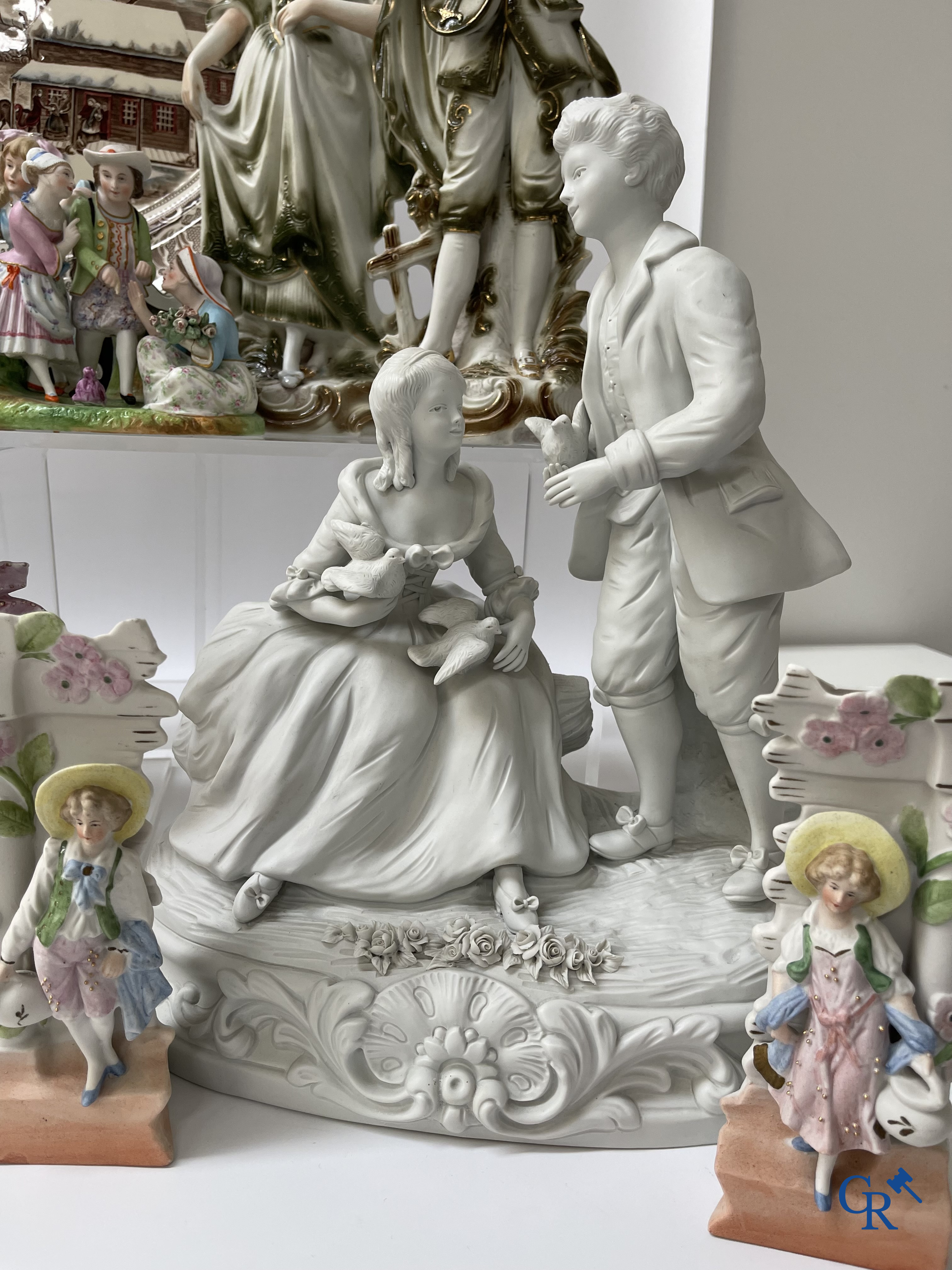 A large lot of brocante including Royal Dux, Biscuit statues, porcelain, globes, spelter statues, table lamp, chandelier etc.