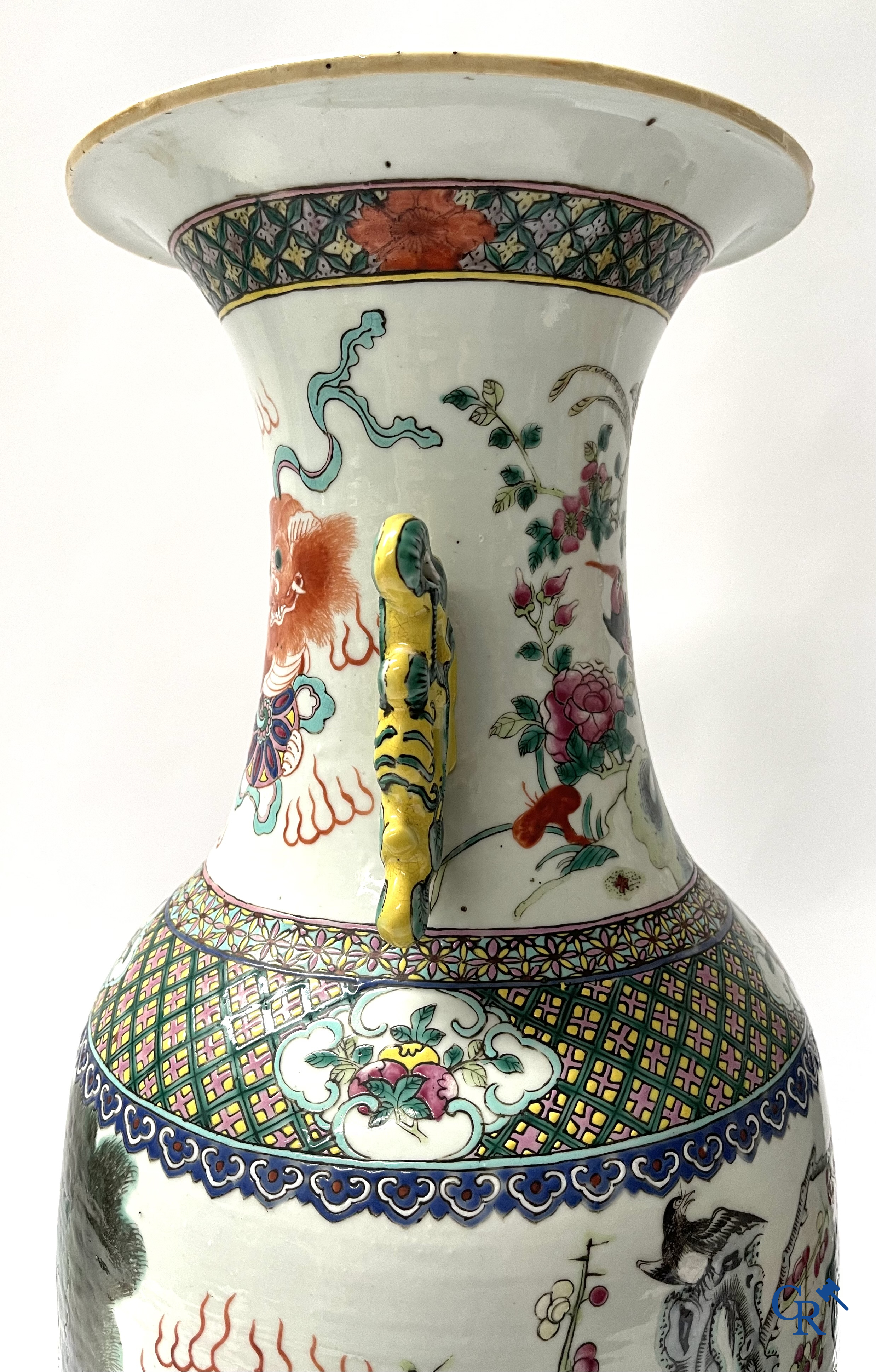 Asian Art, A pair of Chinese famille rose vases with peacocks and Fo dogs. 19th century.