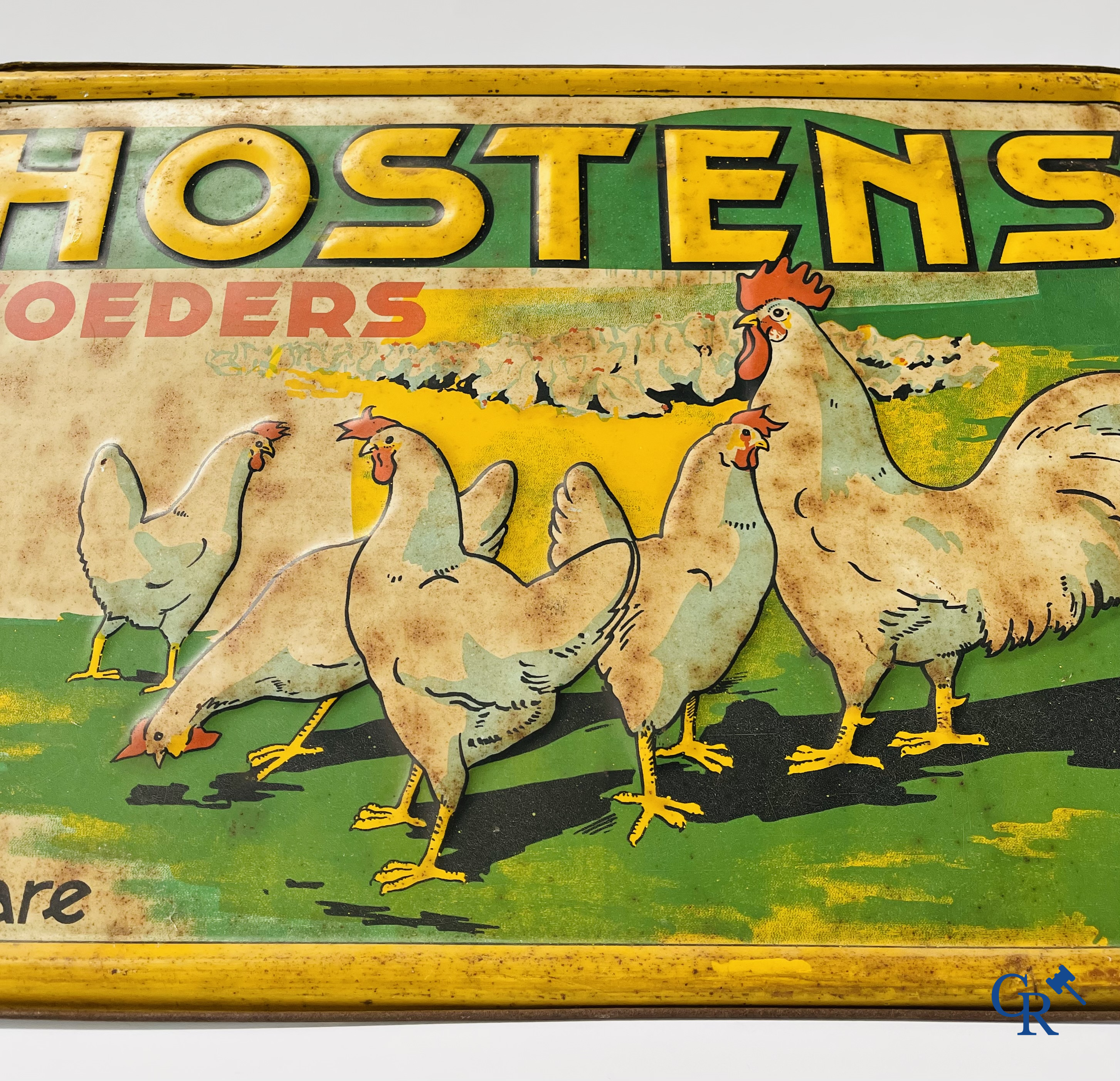 Voeders Hostens. Reclamebord in beschilderd blik voor kippenvoer van voederbedrijf Hostens te Roeselare. 1935.