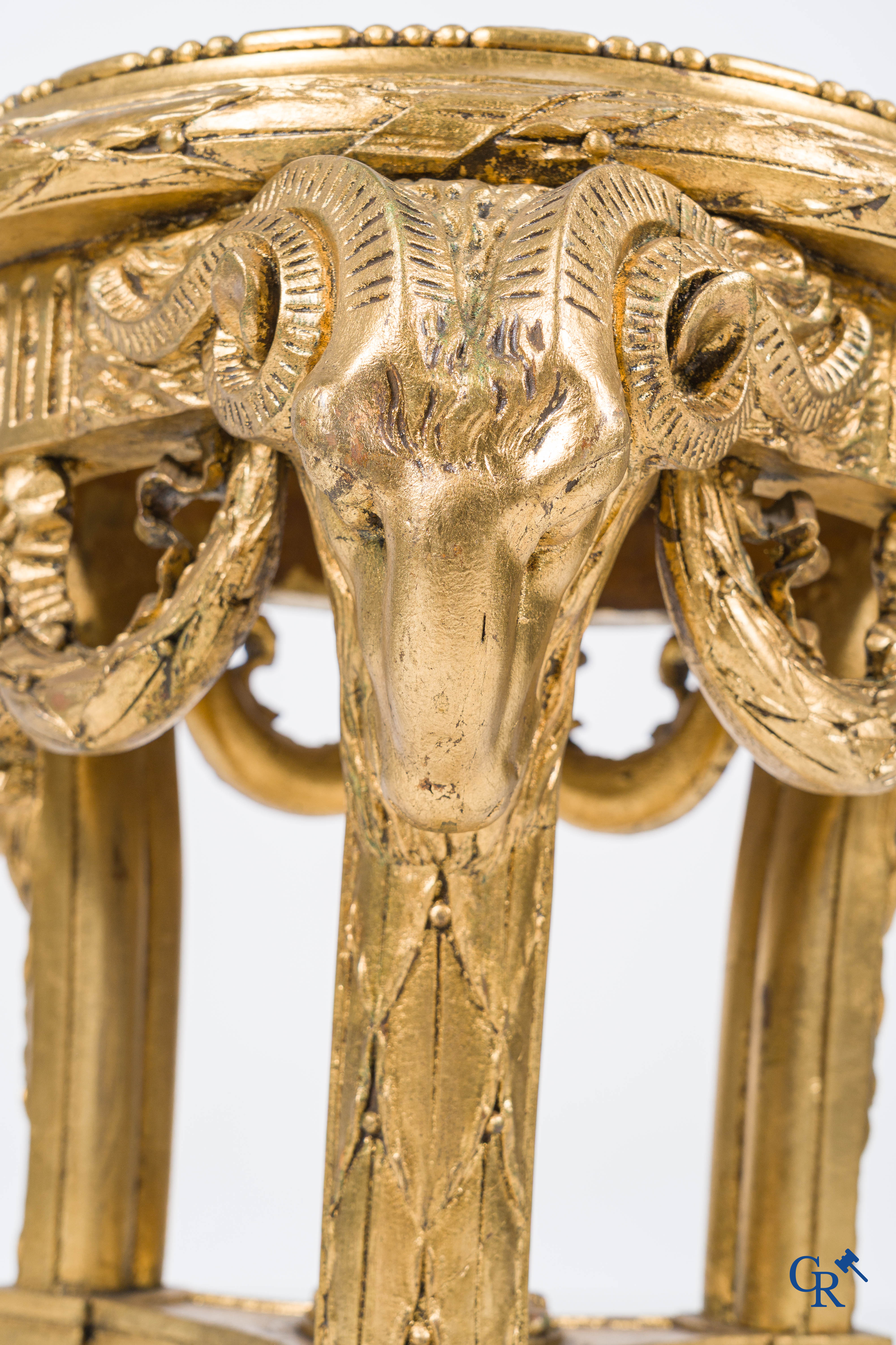 A large wood carved and gilded plinth with ram heads and garlands. LXVI style, circa 1900.