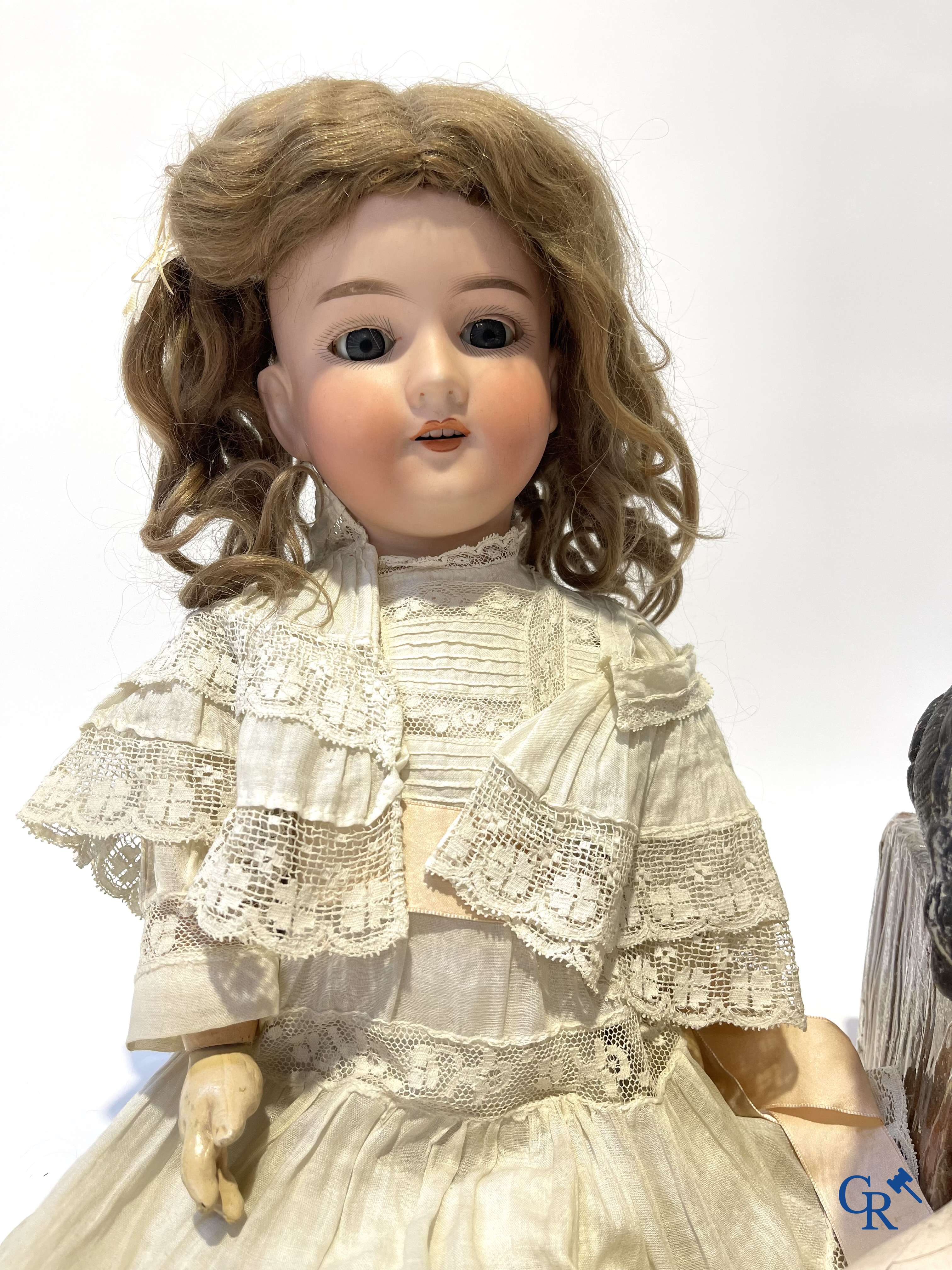 Old toys, an antique doll with porcelain head marked Armand Marseille and a bust in papier-mâché.