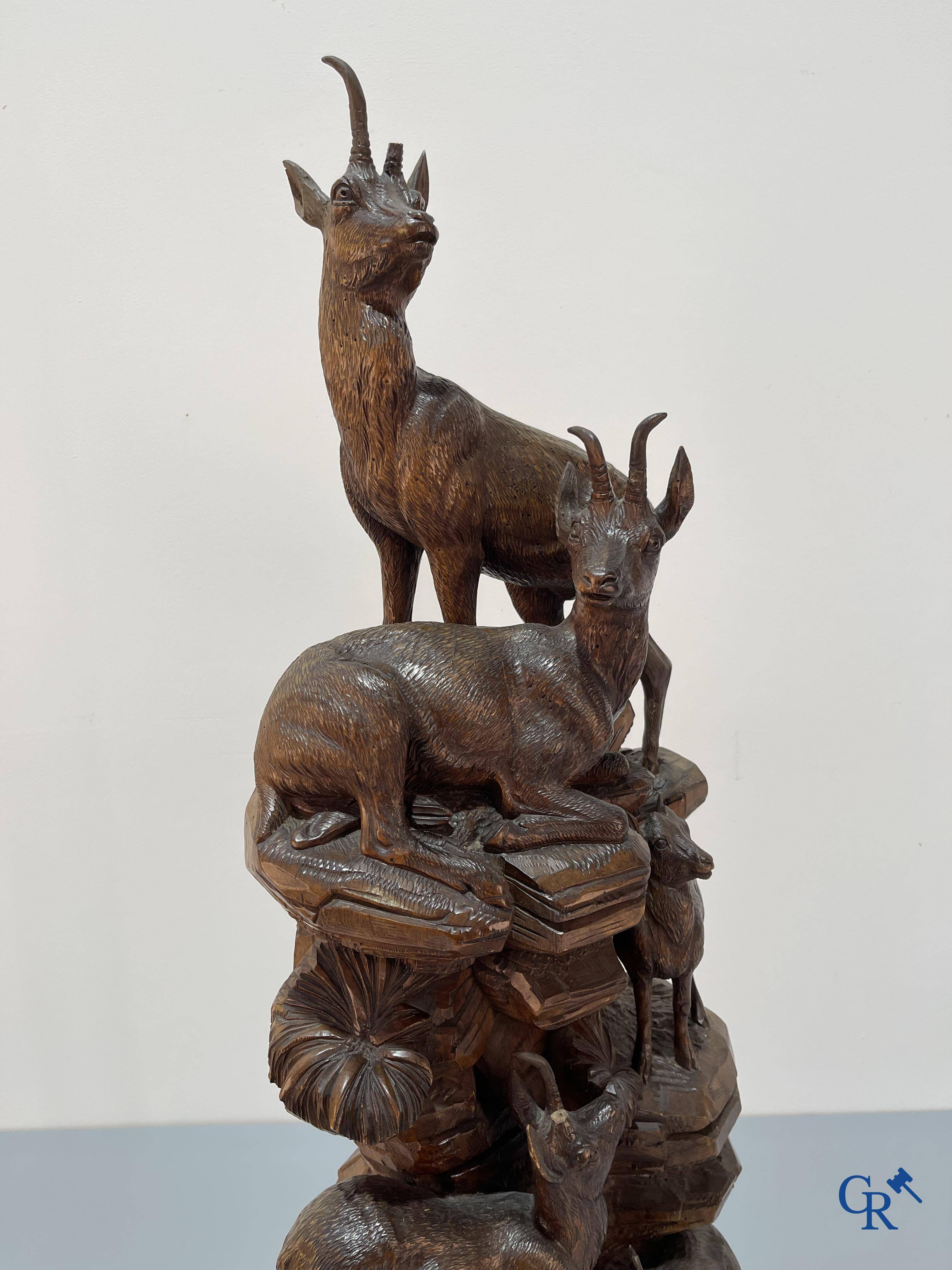 Imposing wood sculpture with chamois on a rocky mountain landscape in so-called "black forest". German work, late 19th century.