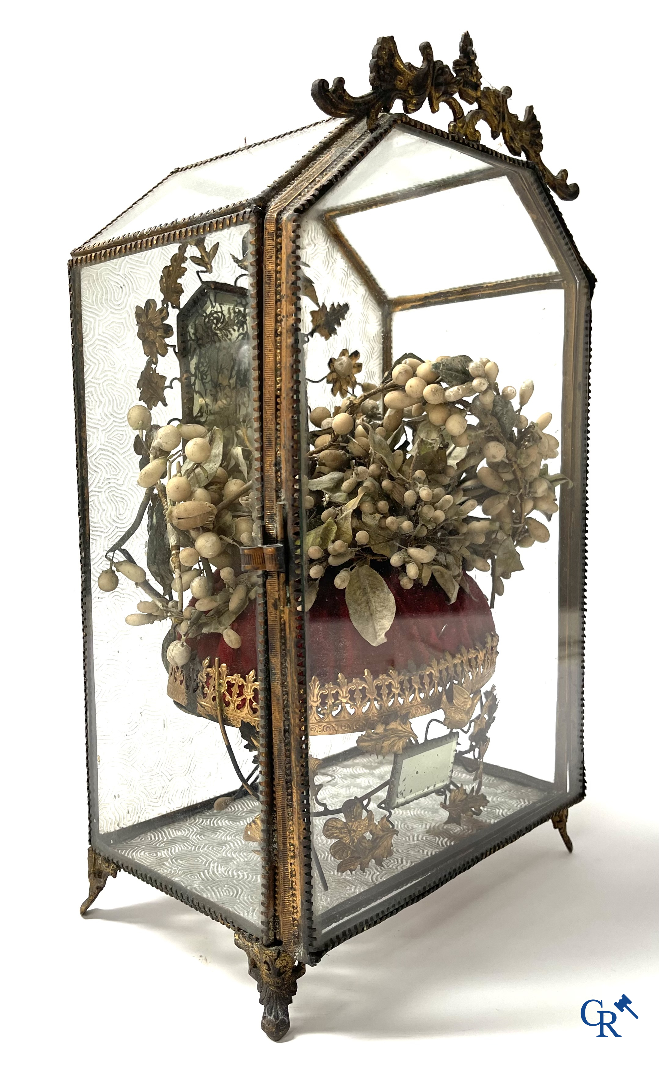 A globe in glass with a child in wax and a brass display case with bridal bouquet. Around 1900.
