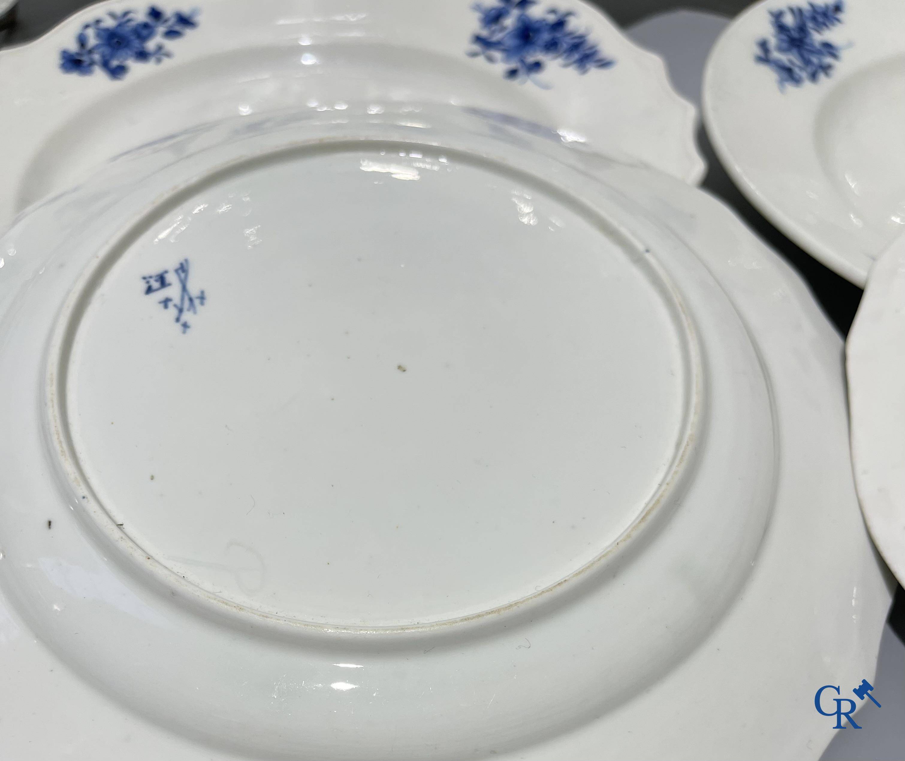 European porcelain, Tournai. 13 plates with blue decor and a large monochrome dish. 18th century.