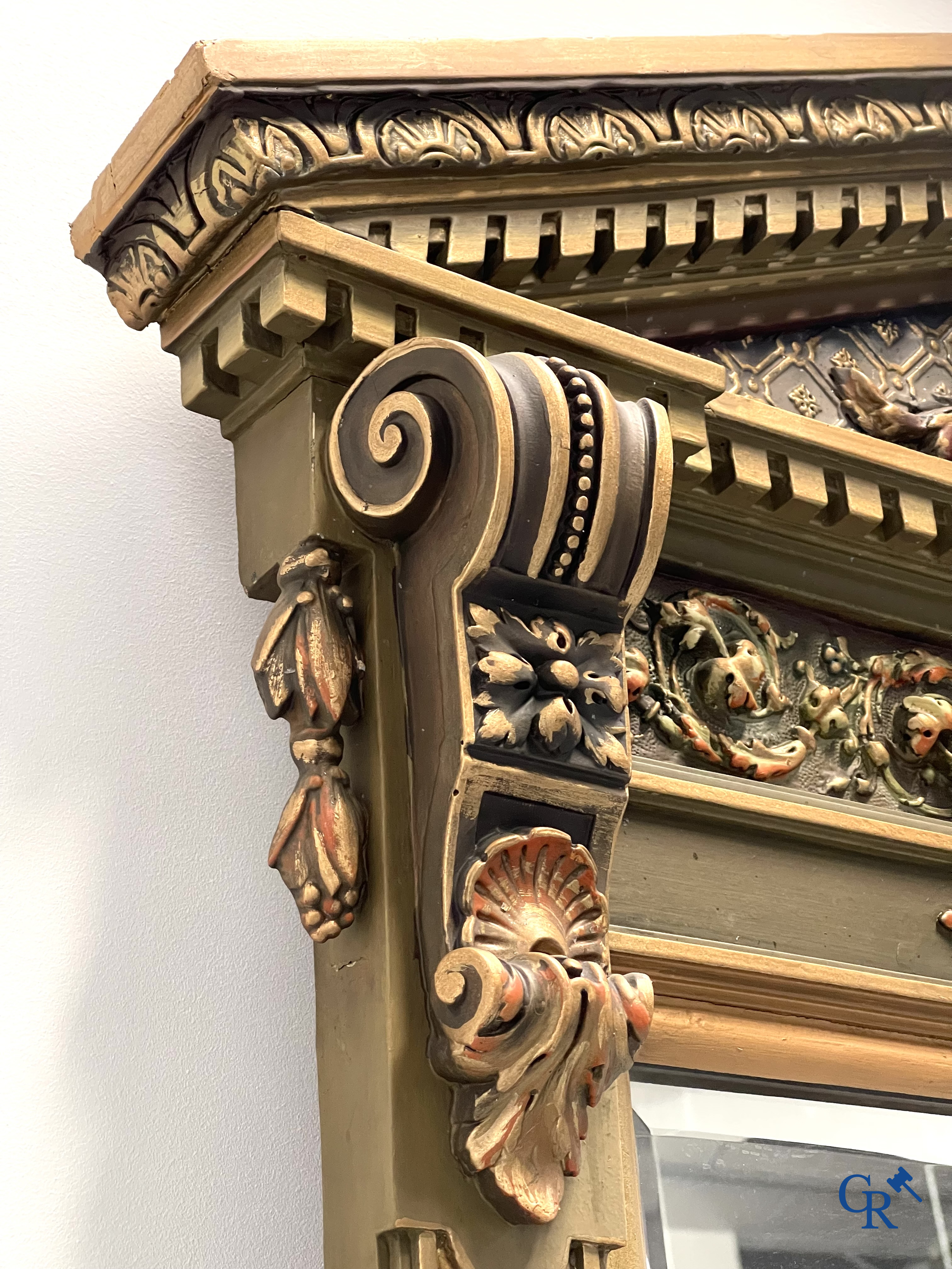 A large patinated fireplace mirror with a dragon. Around 1900.