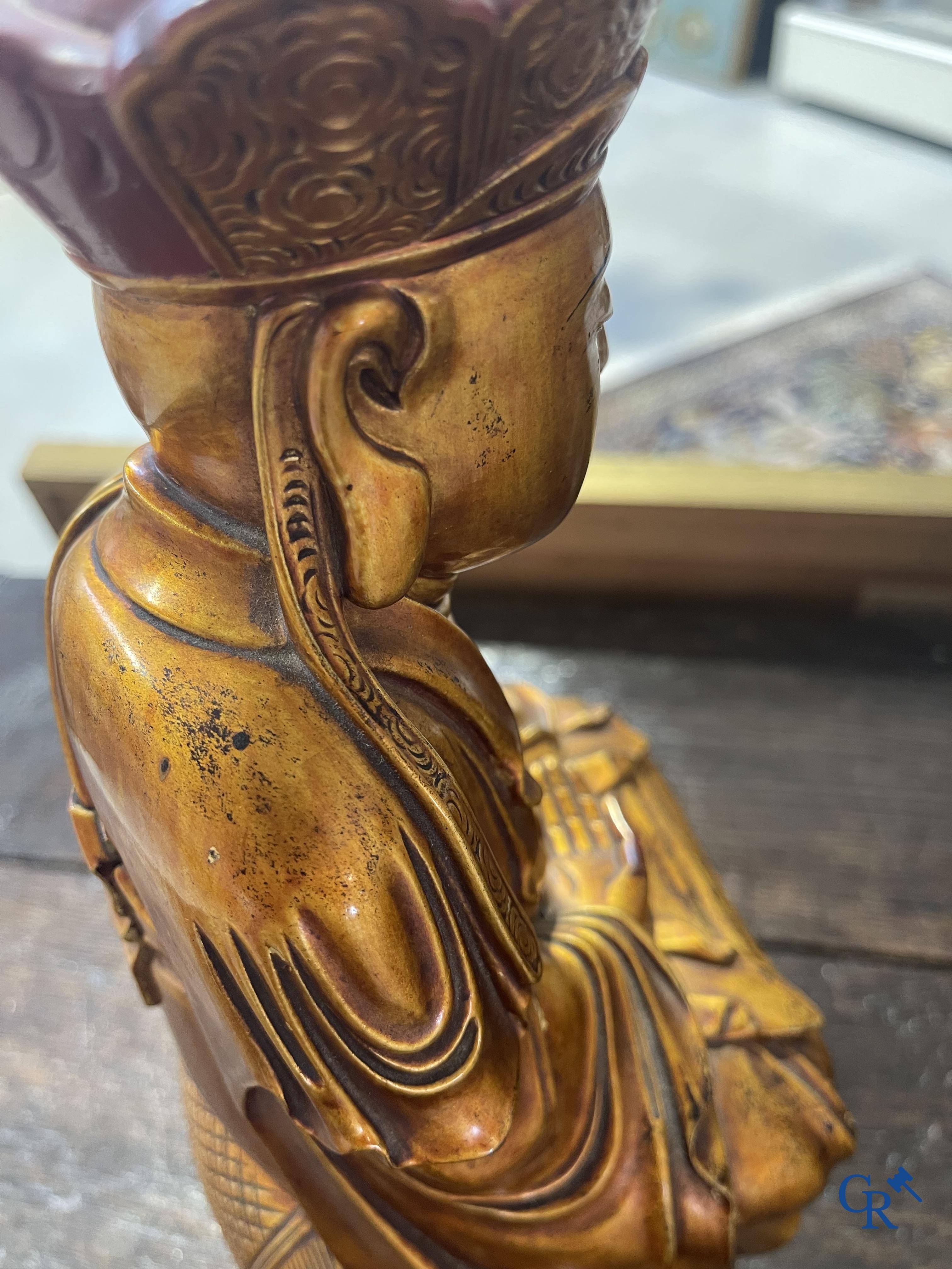Asian Art: A Chinese sculpture of Vaishravana on a Buddhist lion in lacquered and gilded wood. 19th century.