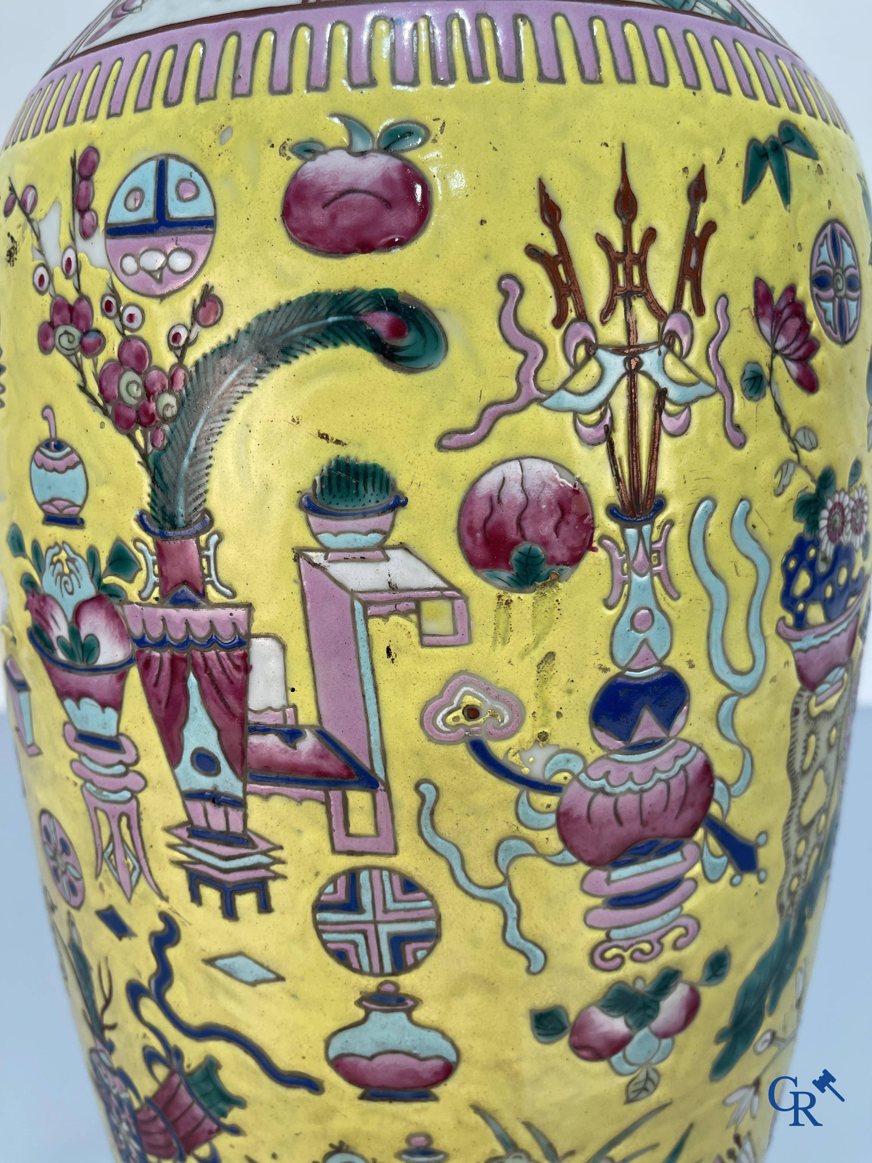 Asian Art, Chinese porcelain, a large Chinese famille jaune and rose vase with a decor of antiques. 19th century.