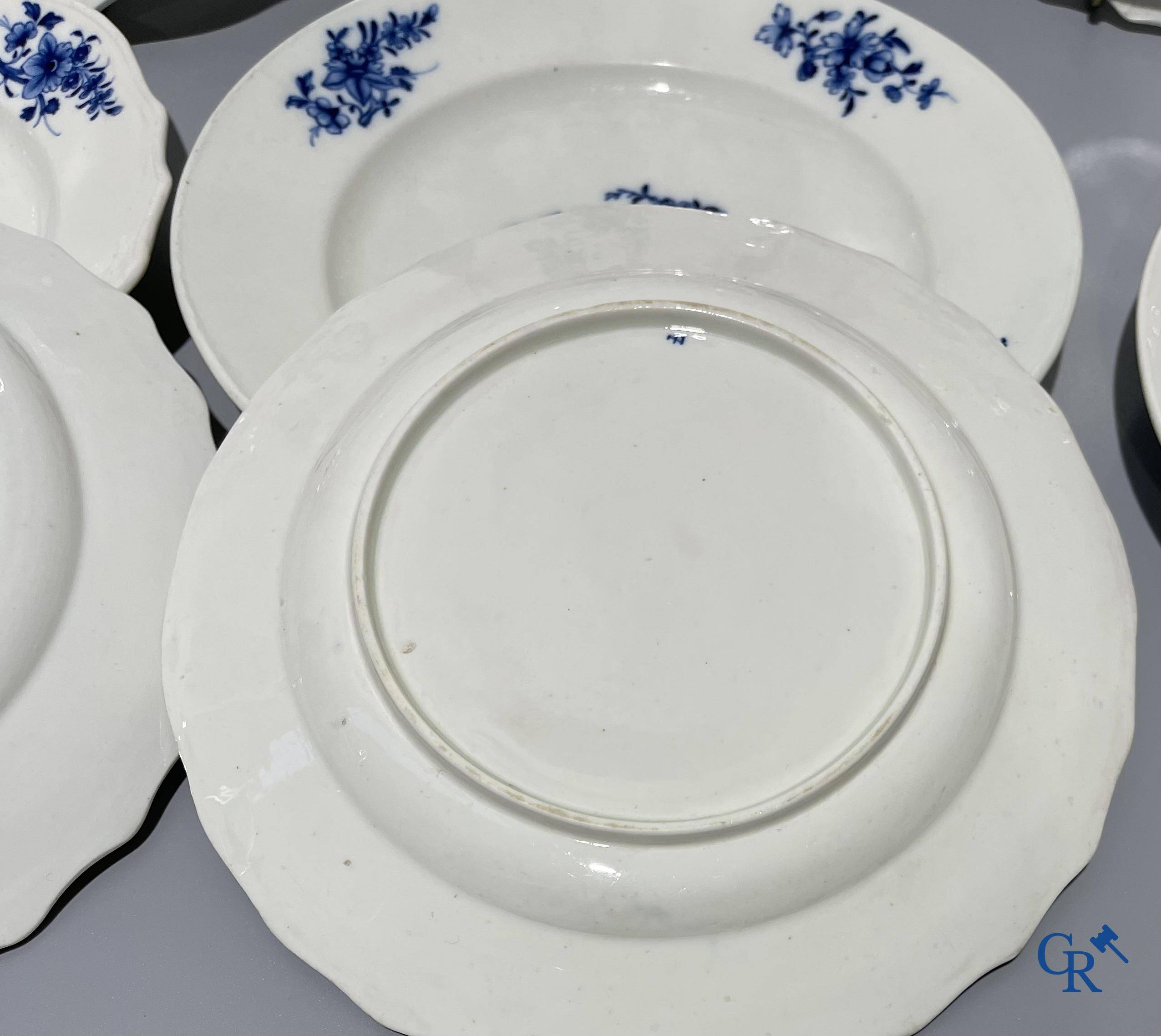 European porcelain, Tournai. 13 plates with blue decor and a large monochrome dish. 18th century.