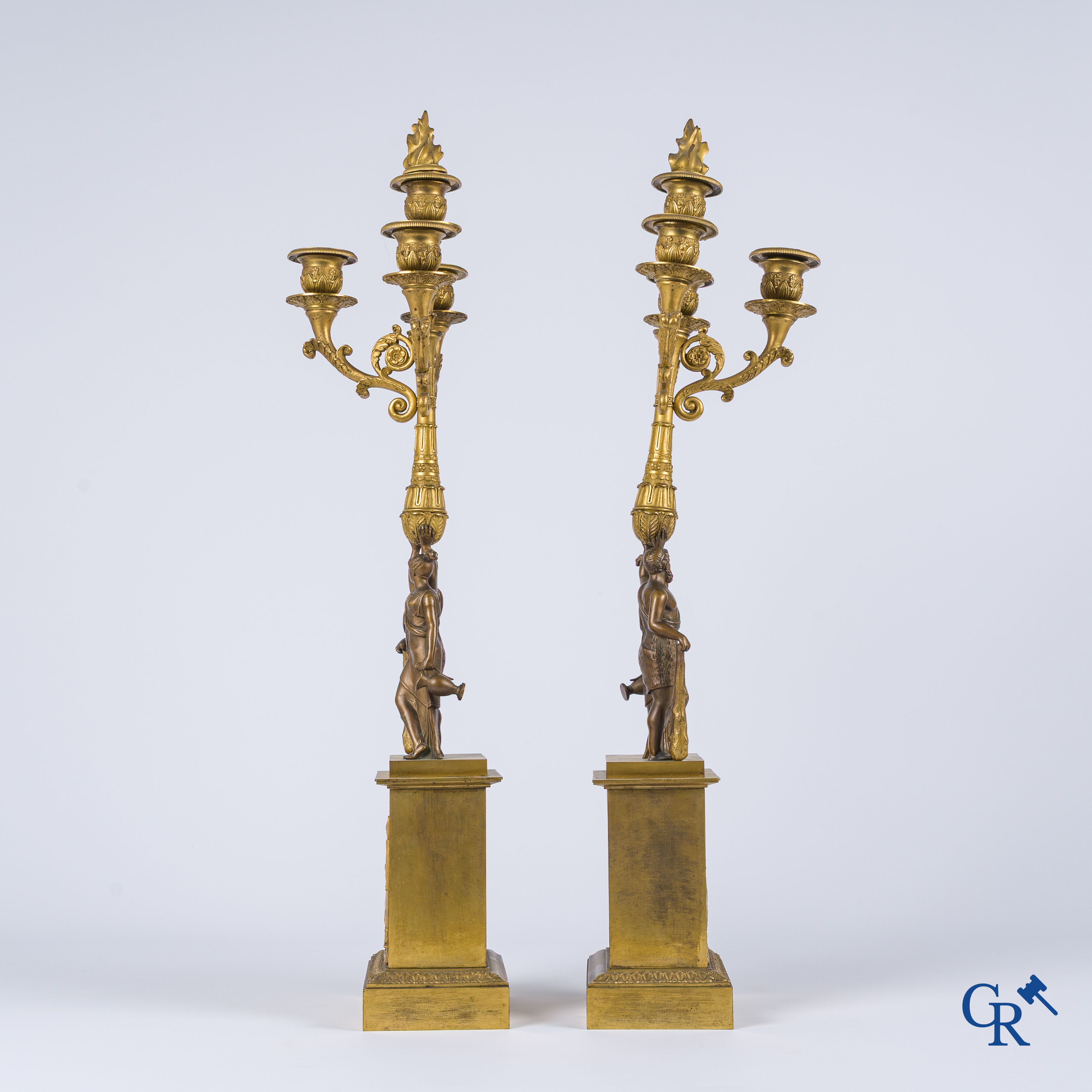 Empire era. A pair of large bronze candlesticks with characters in the antique style. Empire, circa 1815.