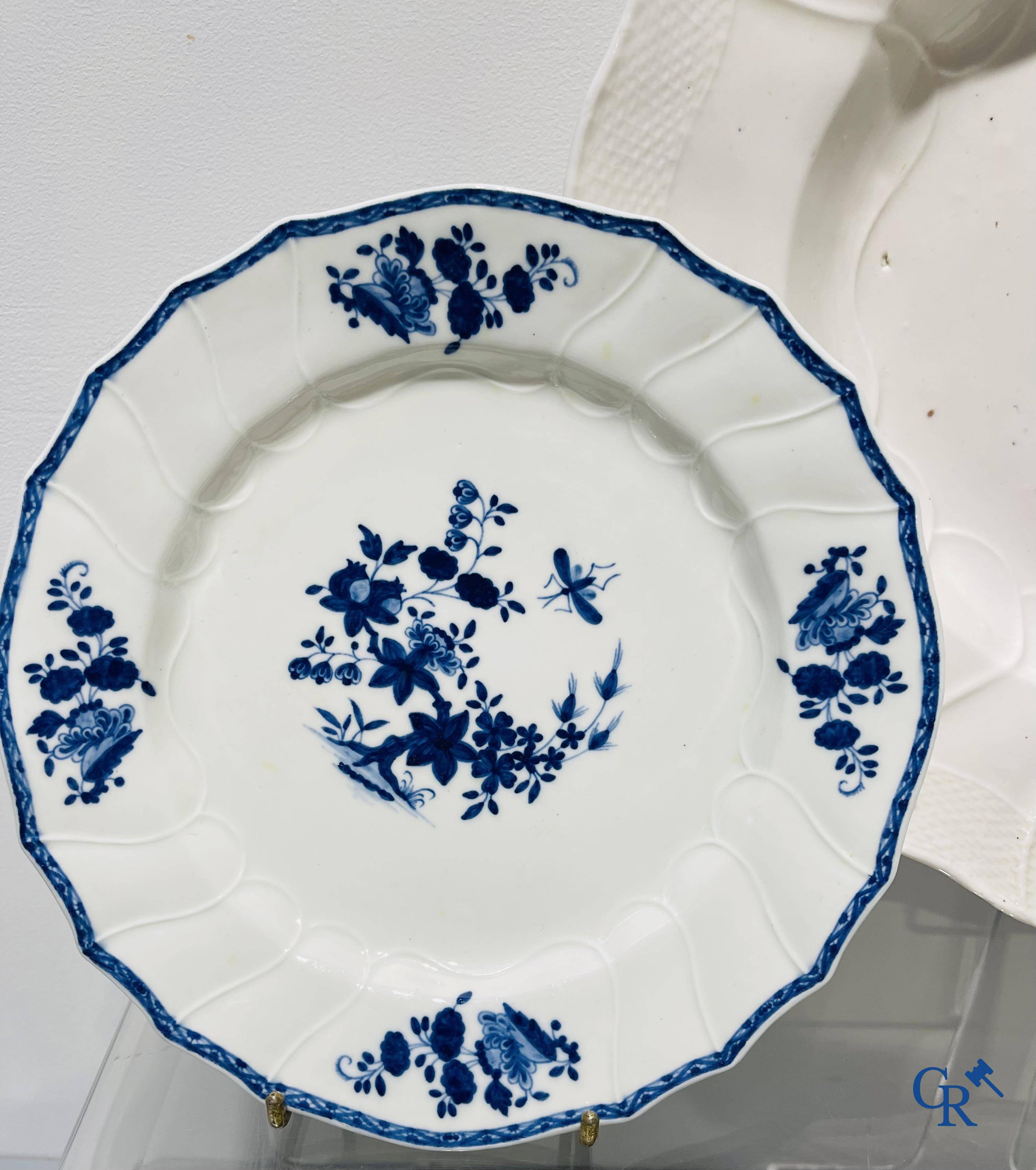 European porcelain, Tournai. 13 plates with blue decor and a large monochrome dish. 18th century.