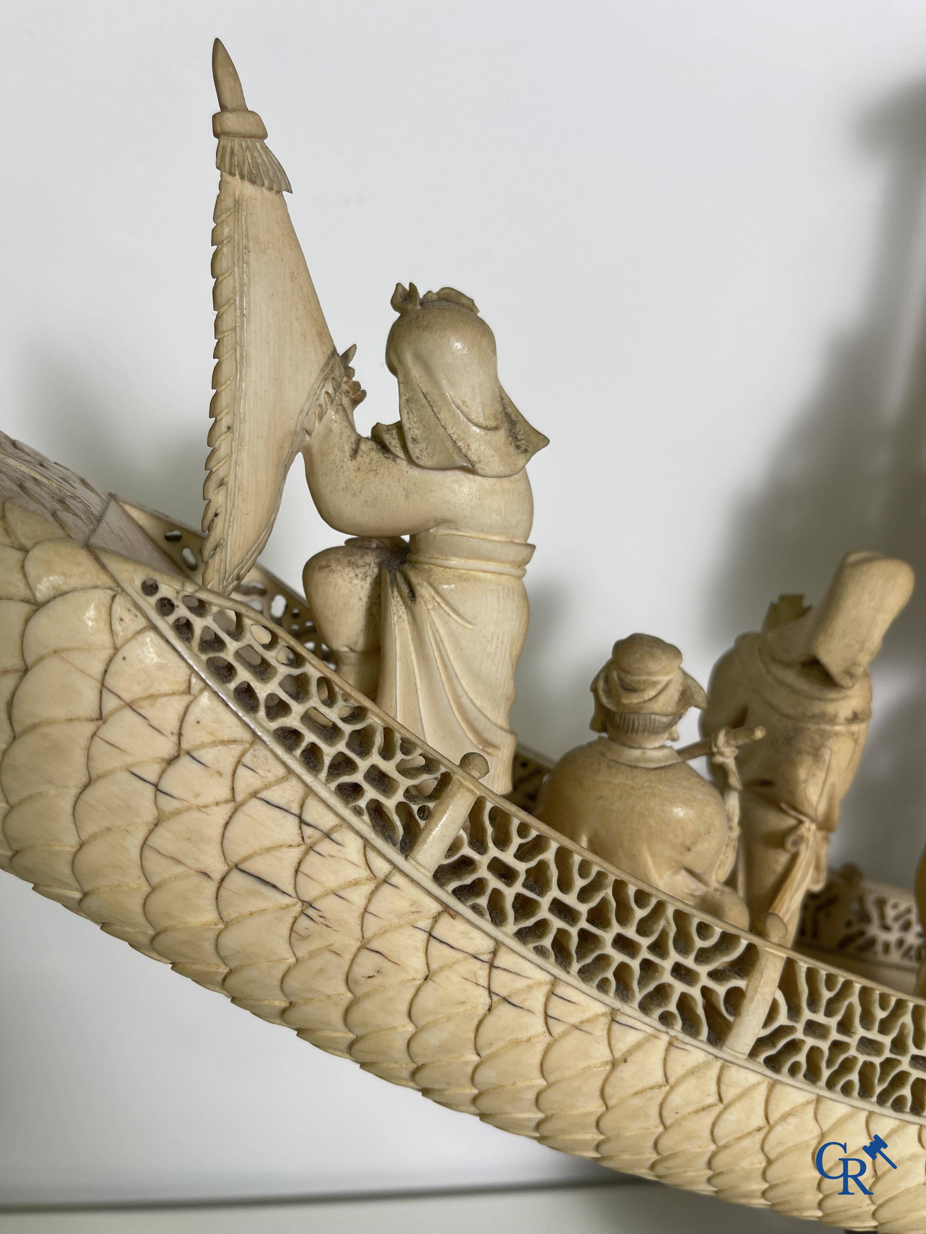 Asian Art: A large Chinese ivory dragon boat on a wooden pedestal. 19th century.