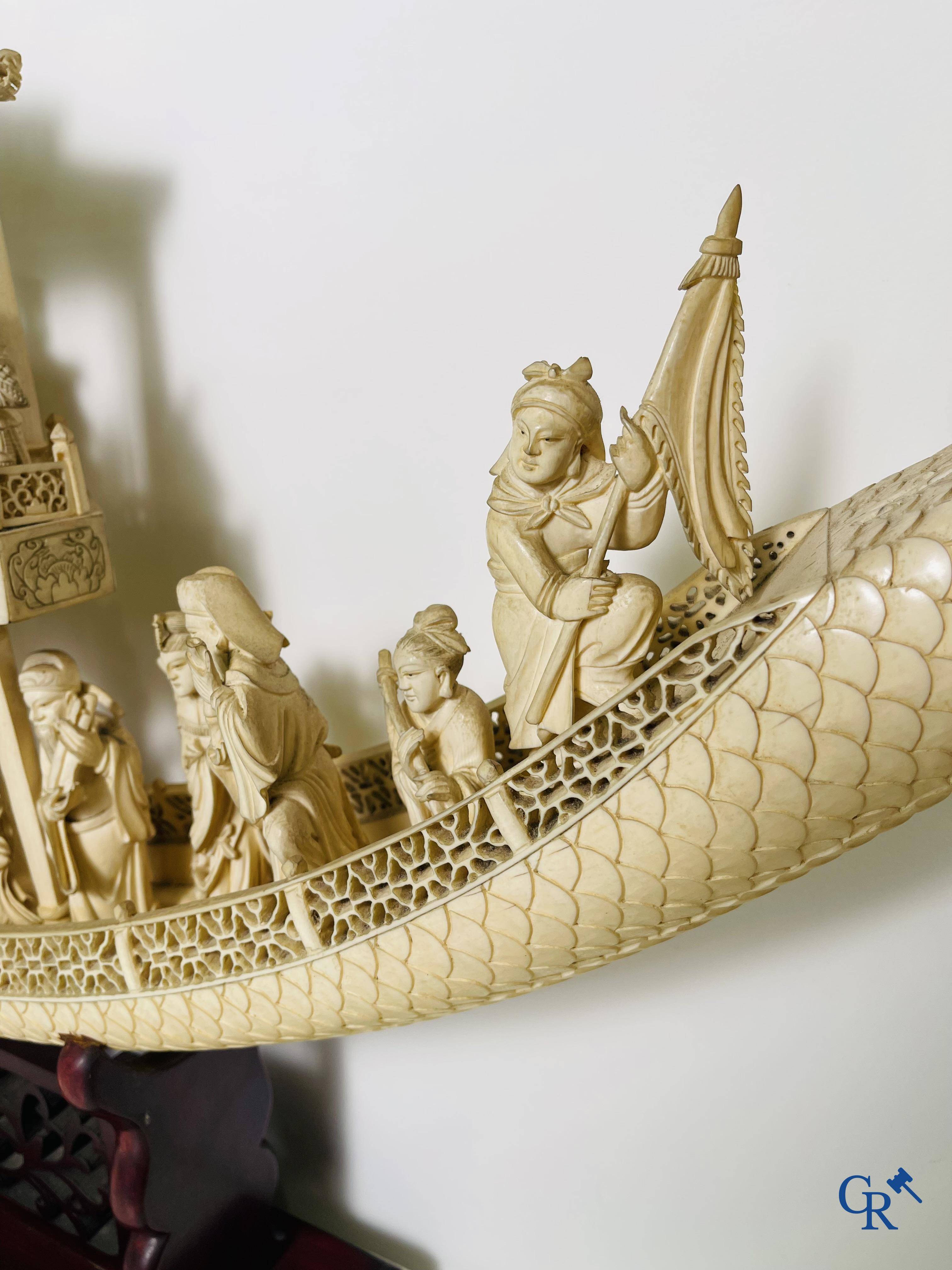 Asian Art: A large Chinese ivory dragon boat on a wooden pedestal. 19th century.