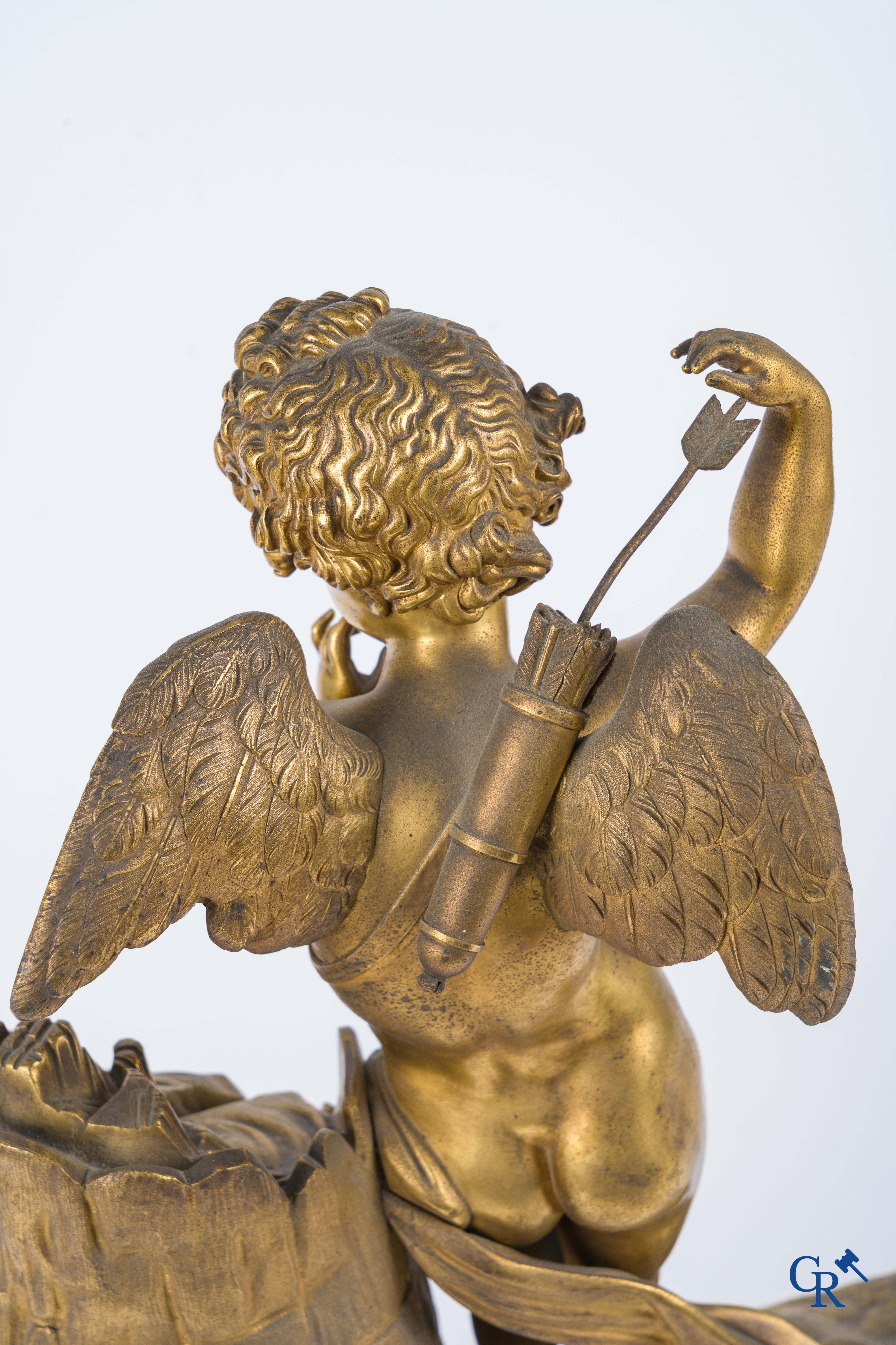 Charles X, a pendulum with finely chiseled cupid in gilded bronze. Red veined marble pedestal, circa 1840.