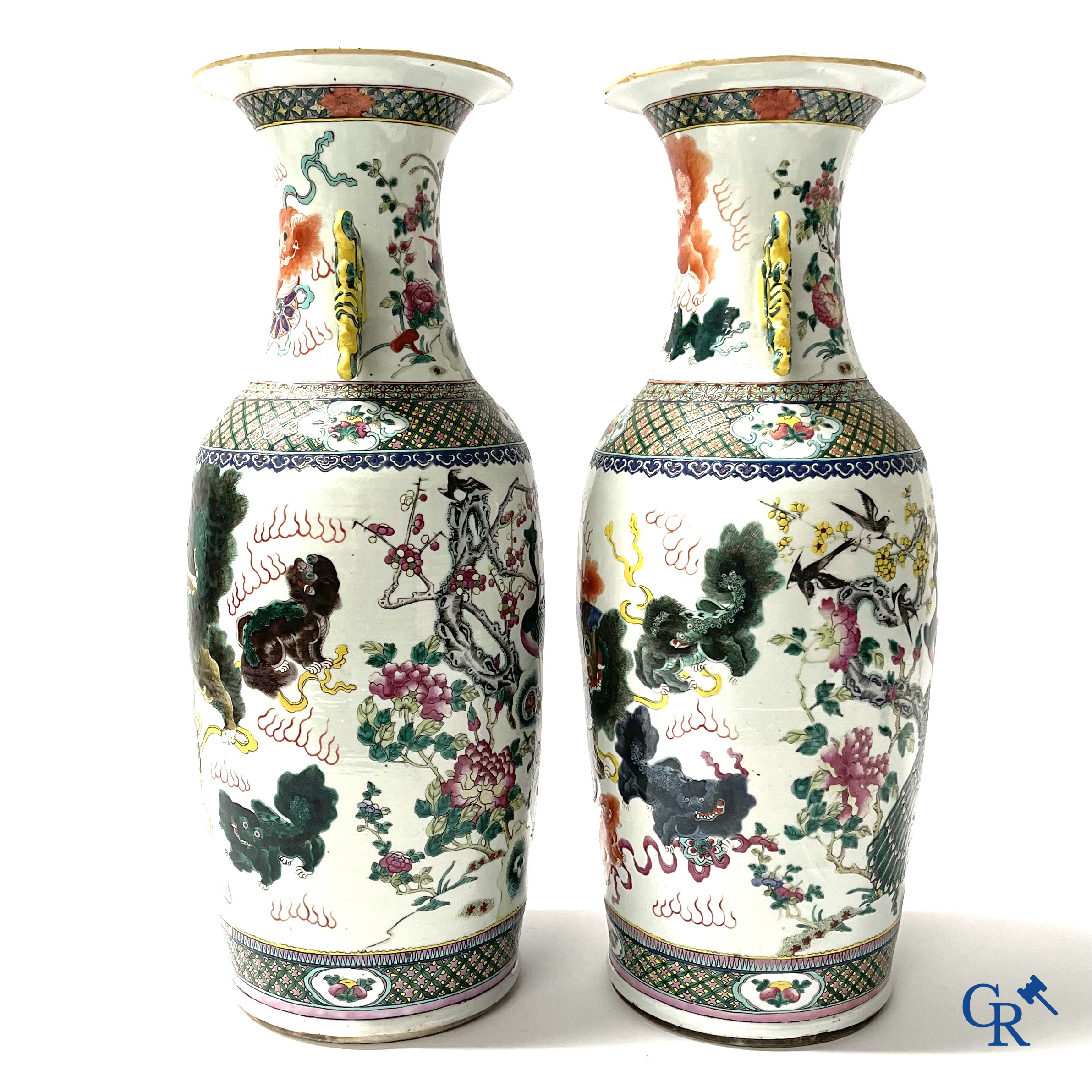 Asian Art, A pair of Chinese famille rose vases with peacocks and Fo dogs. 19th century.