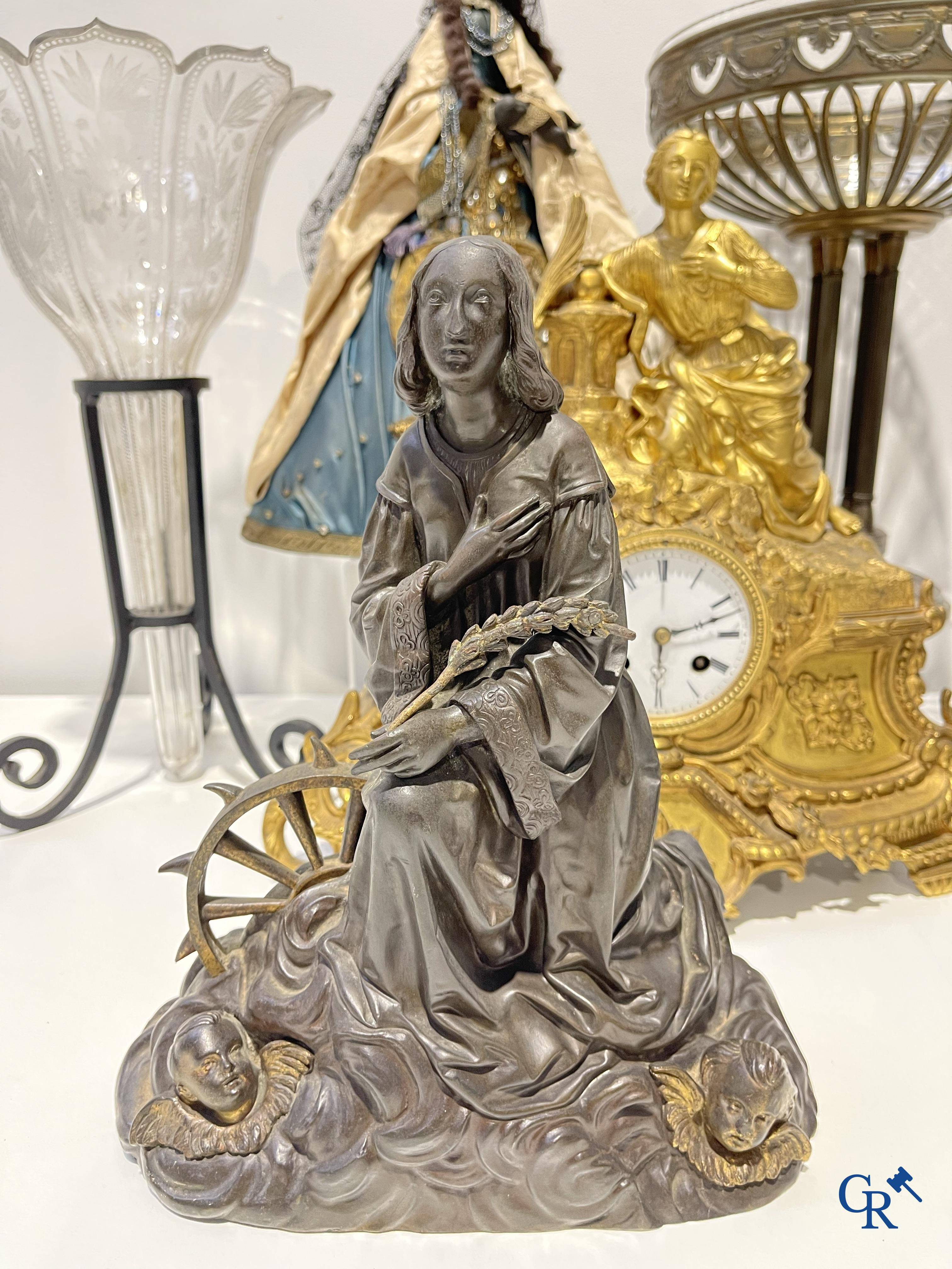 A lot with brocante: Bronze clock, bronze neo Gothic candlesticks and a statue of St. Catharina, soliflore etc.
