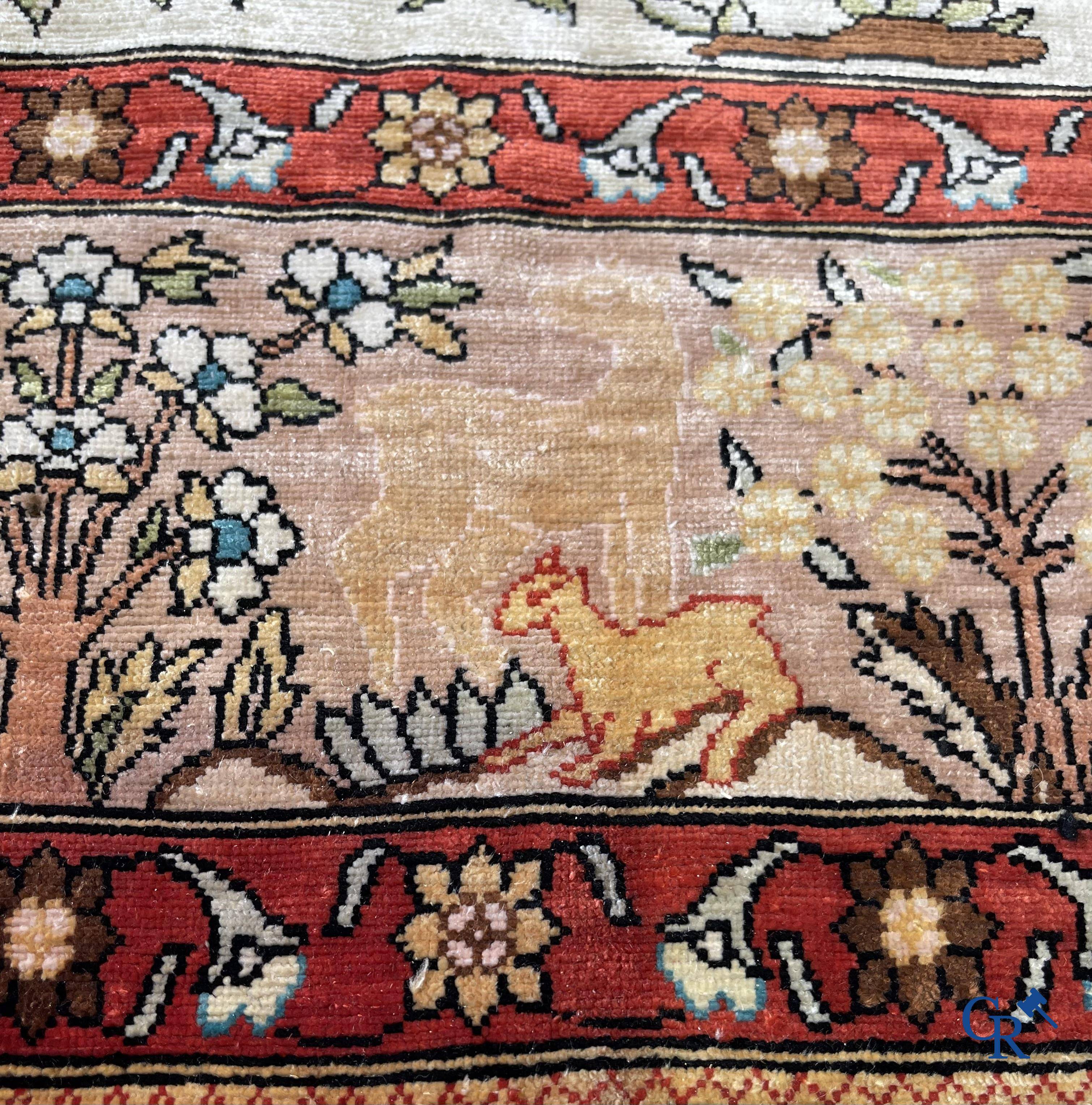 Oriental rugs, a fine hand-knotted silk tapestry with animals in a forest. Signed.