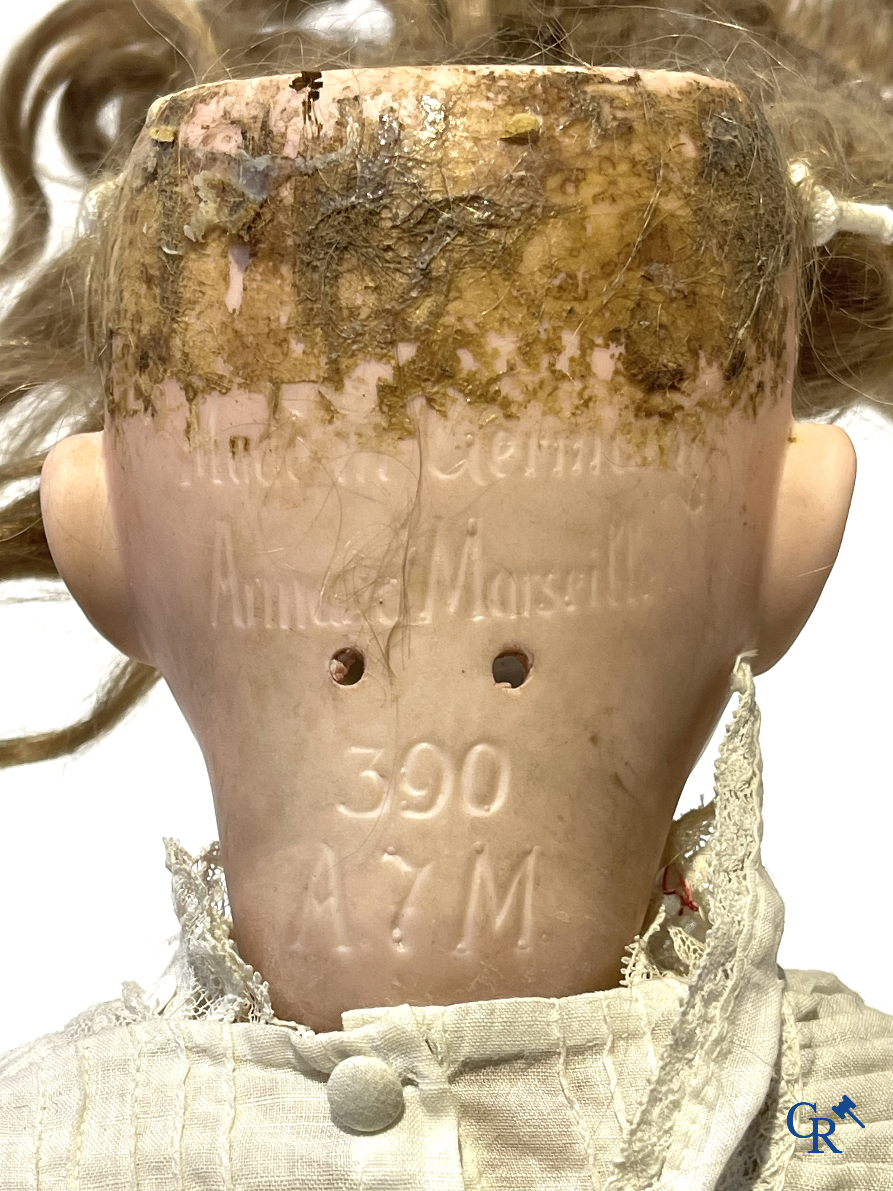 Old toys, an antique doll with porcelain head marked Armand Marseille and a bust in papier-mâché.