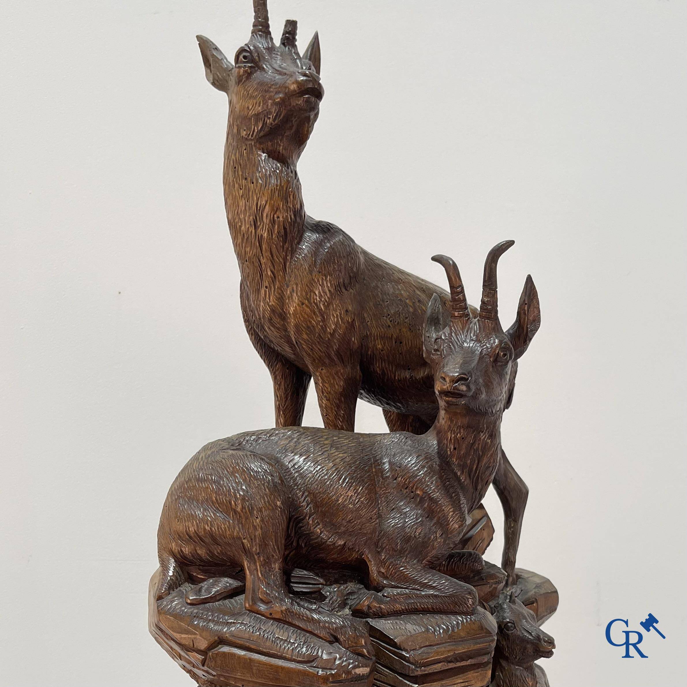 Imposing wood sculpture with chamois on a rocky mountain landscape in so-called "black forest". German work, late 19th century.