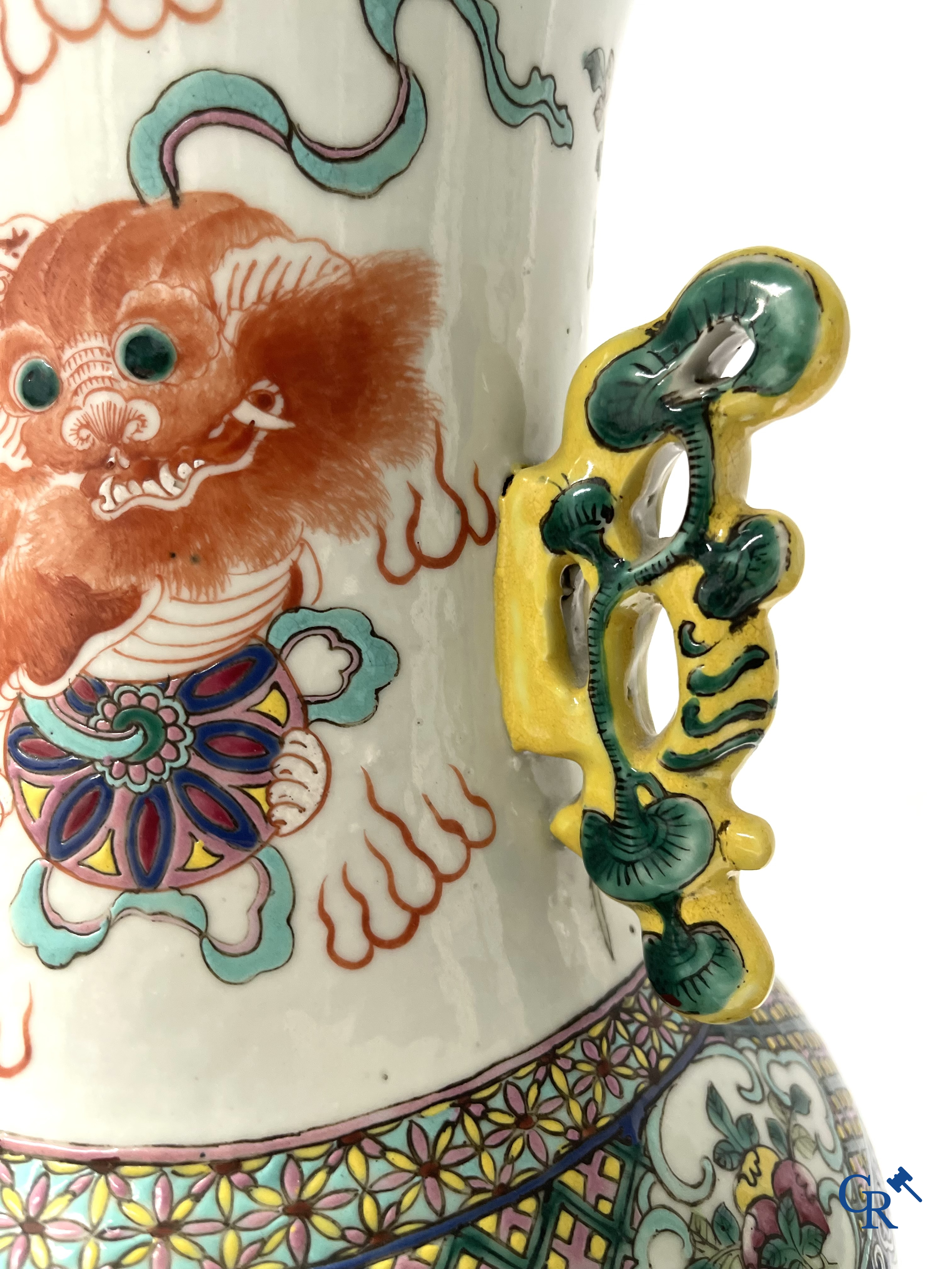 Asian Art, A pair of Chinese famille rose vases with peacocks and Fo dogs. 19th century.