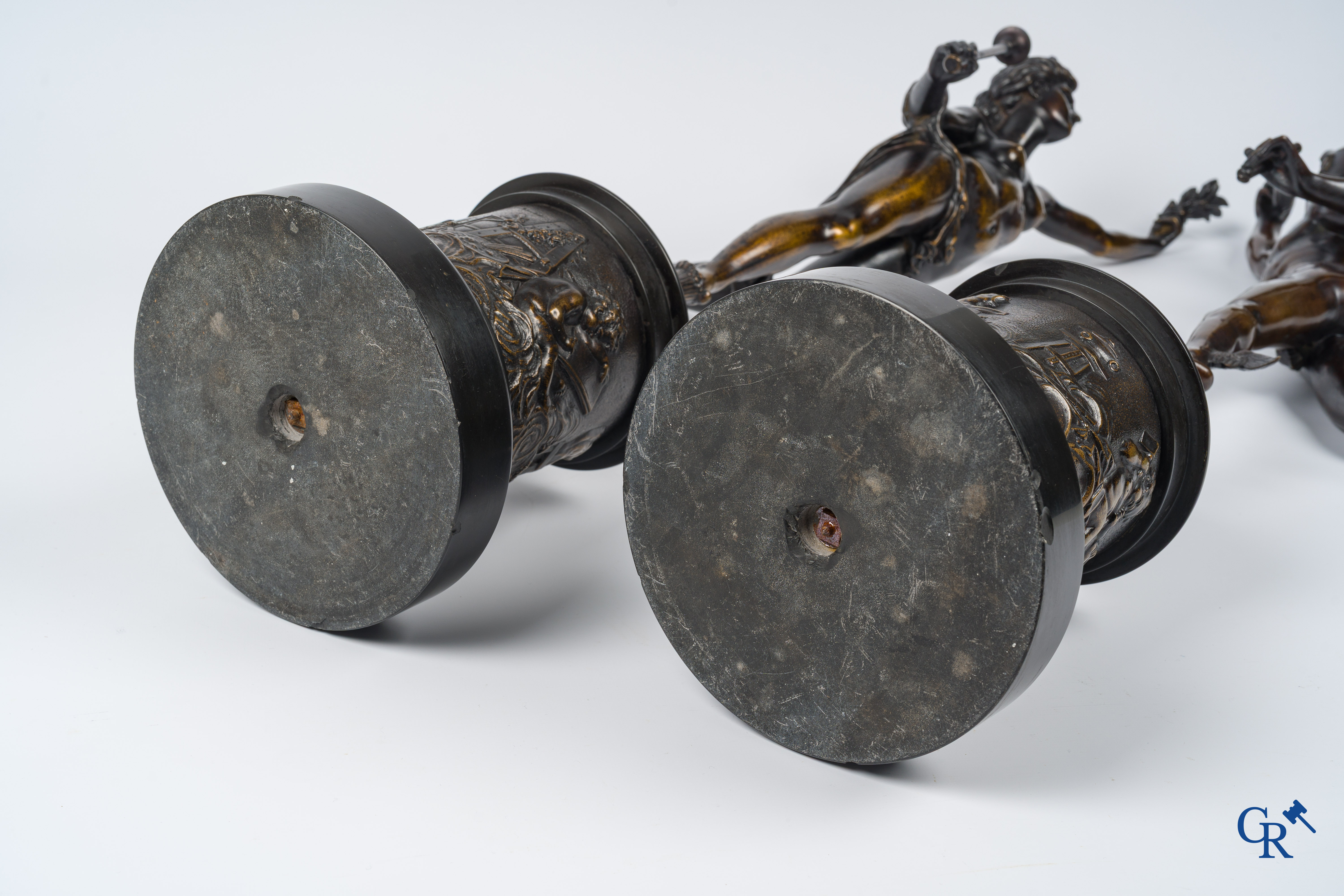 A pair of imposing bronze statues in the antique style after a model by Jean De Bologne.