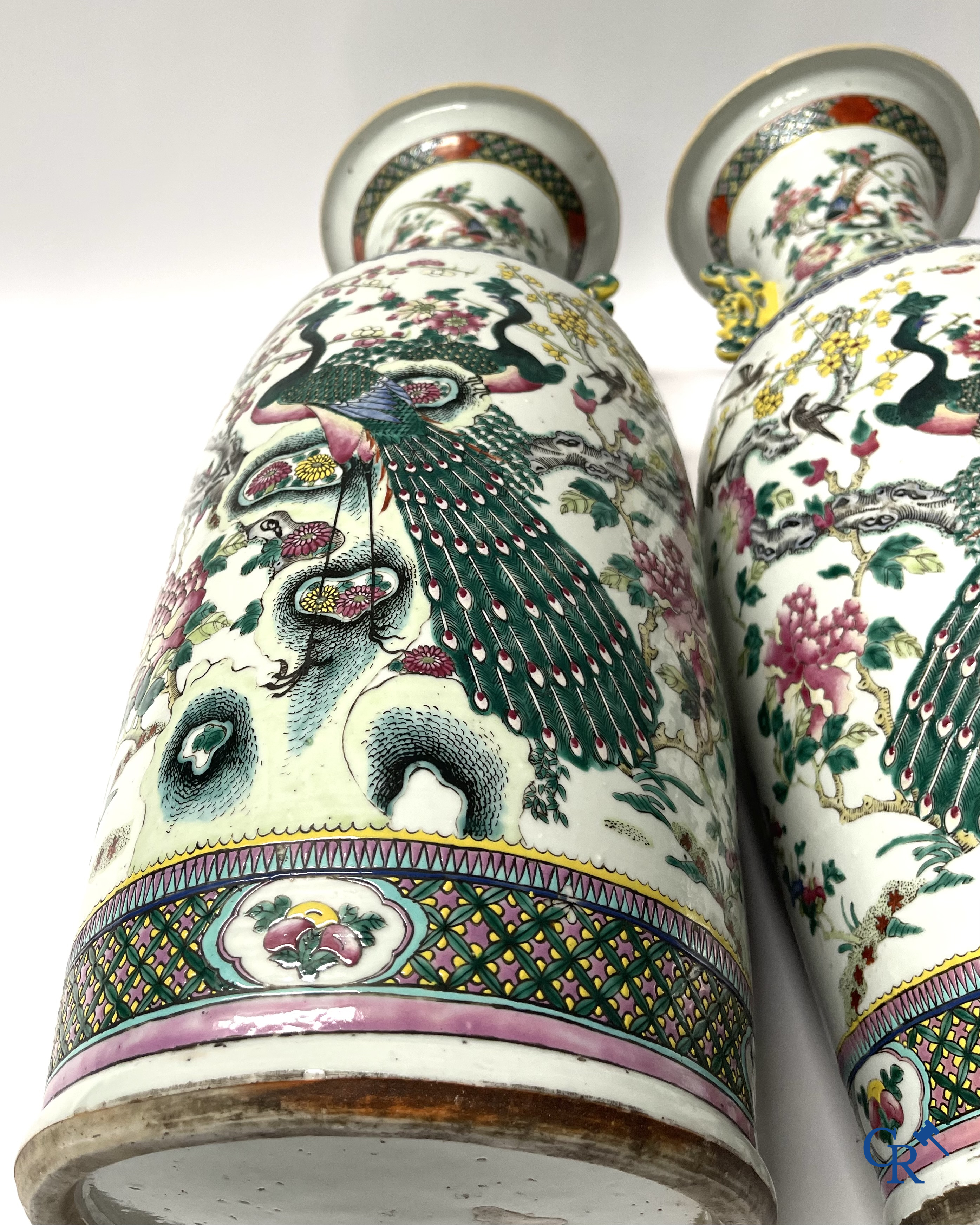 Asian Art, A pair of Chinese famille rose vases with peacocks and Fo dogs. 19th century.