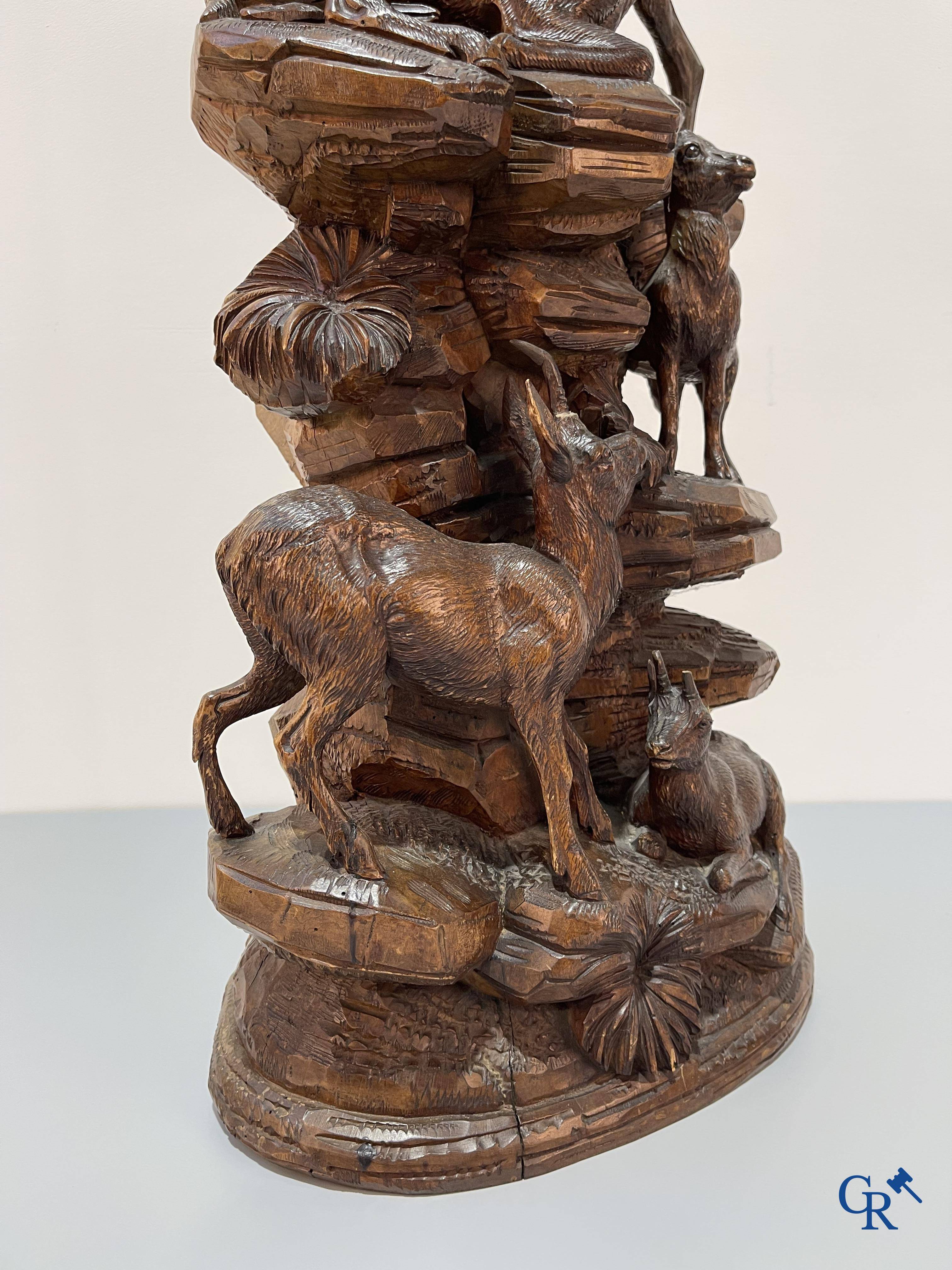 Imposing wood sculpture with chamois on a rocky mountain landscape in so-called "black forest". German work, late 19th century.